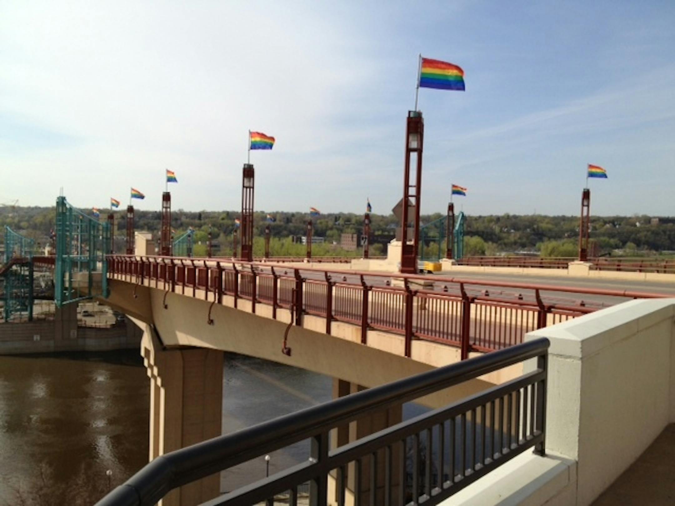 Rainbow flags representing gay pride were hoisted Monday morning by city workers along the Wabasha Bridge in downtown St. Paul.