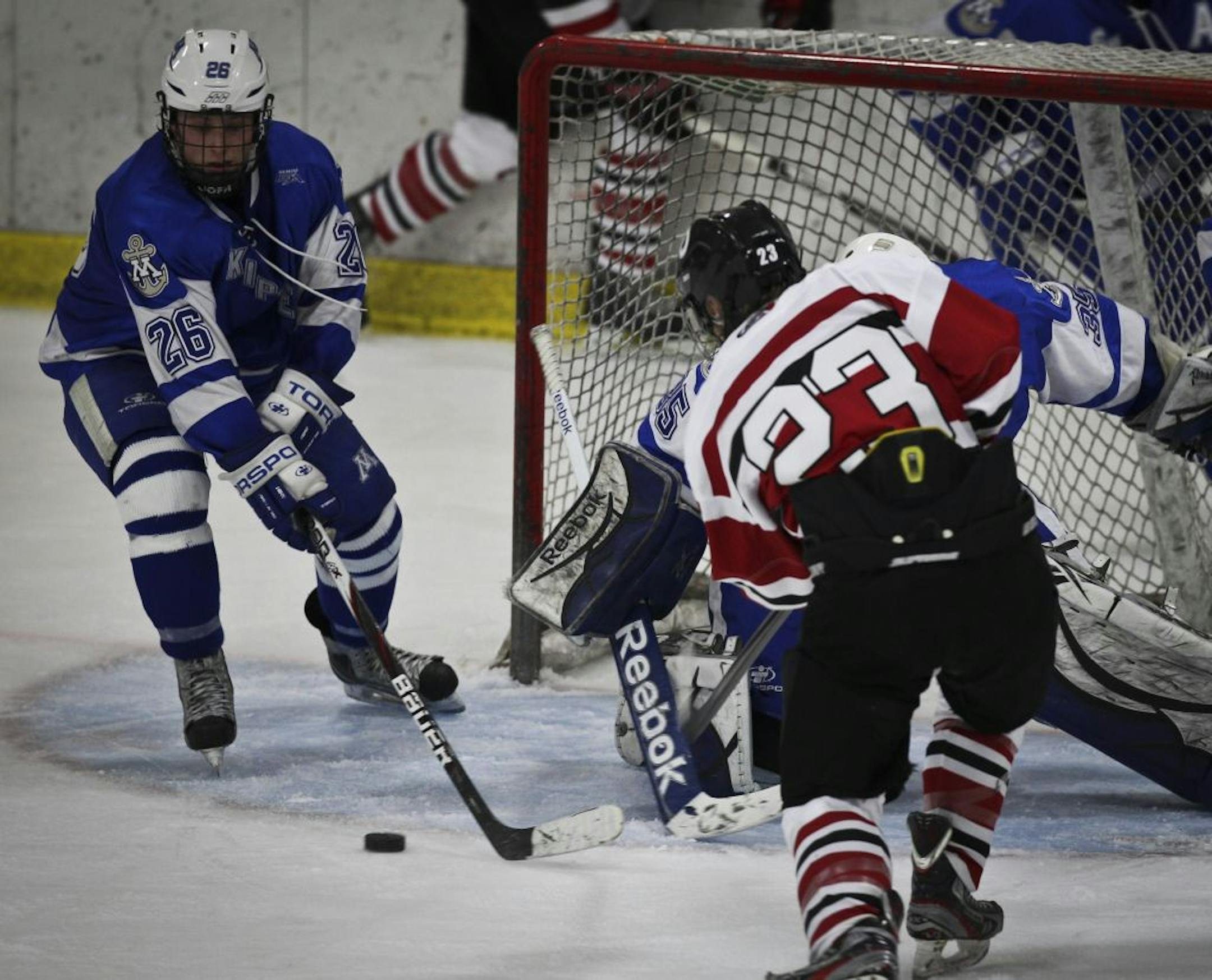 Minnetonka's Jared Ridge tried to assist goalie Paul Ciacco block the puck before Stillwater's Zach Fedie scores the winning goal.