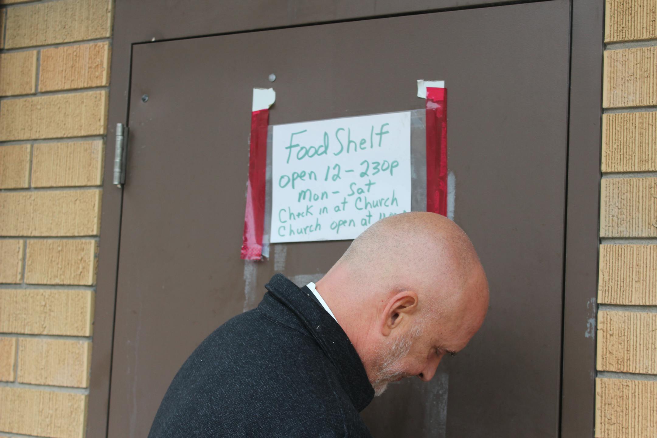 Gethsemane Lutheran Church Pastor Jeff Nehrbass opens the door to the church's food shelf
