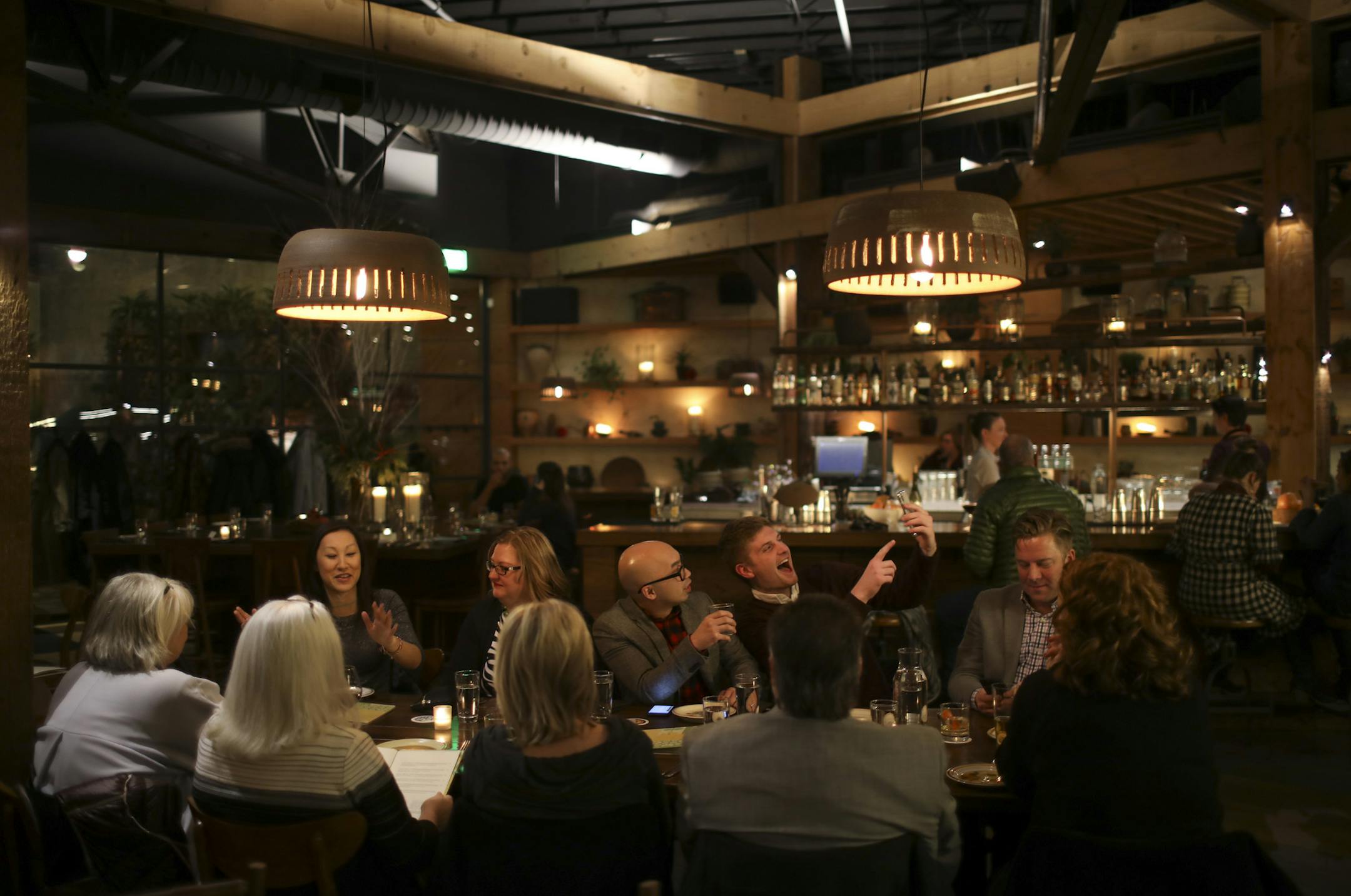 Diners at a long table in the center of the dining room of Young Joni.
