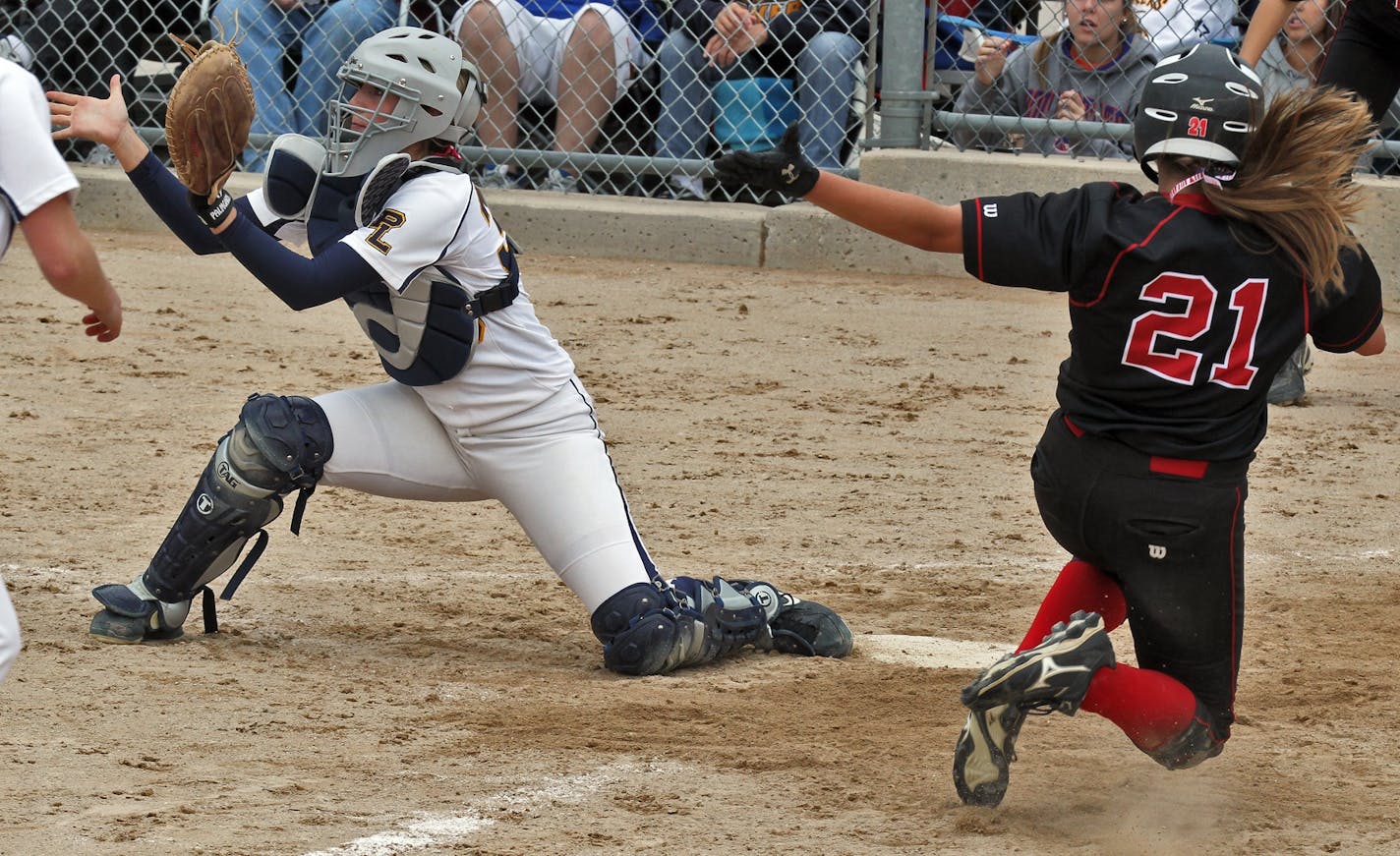 Elk River's Jayme Langbehn scored the winning run in the 7th inning beating the throw to Prior Lake catcher Kara Lattery.