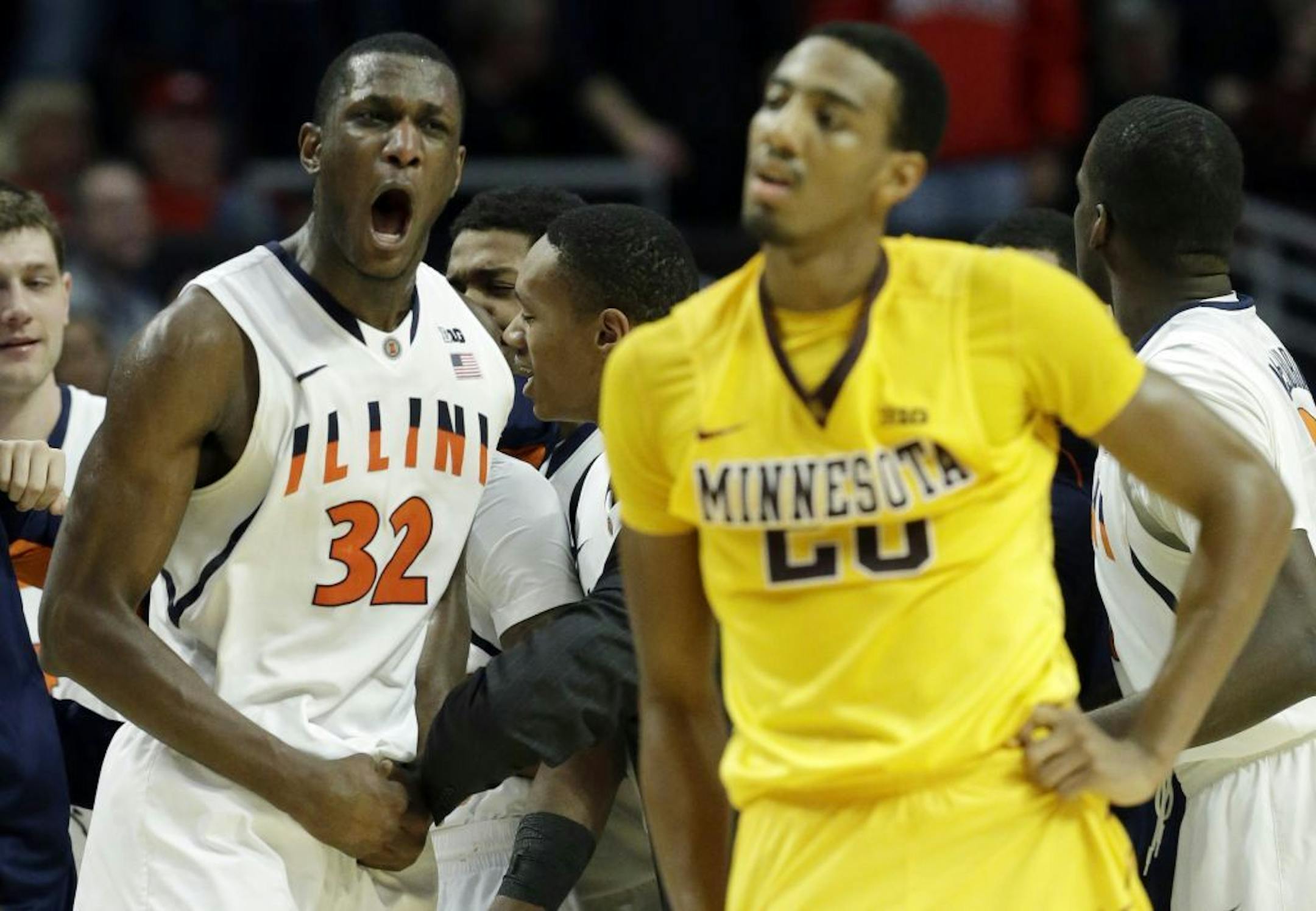 Illinois' Nnanna Egwu reacts in front of Minnesota's Austin Hollins after the second half of an NCAA college basketball game at the Big Ten tournament Thursday, March 14, 2013, in Chicago. Illinois won 51-49.