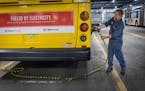 Metro Transit electrician Dan Aasen demonstrates how the electric buses are charged at the Metro Transit Heywood ] Elizabeth Flores • liz.flores@sta