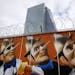A graffiti is painted on a fence around the construction site of the new headquarters of the European Central Bank in Frankfurt, Germany, Wednesday, M