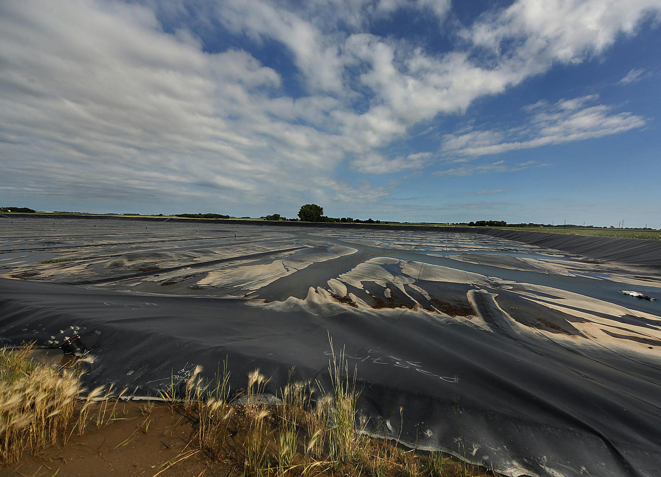 Manure from 3,000 milk cows is kept in a covered basin as part of the environmentally friendly process to generate and sell electricity from manure.