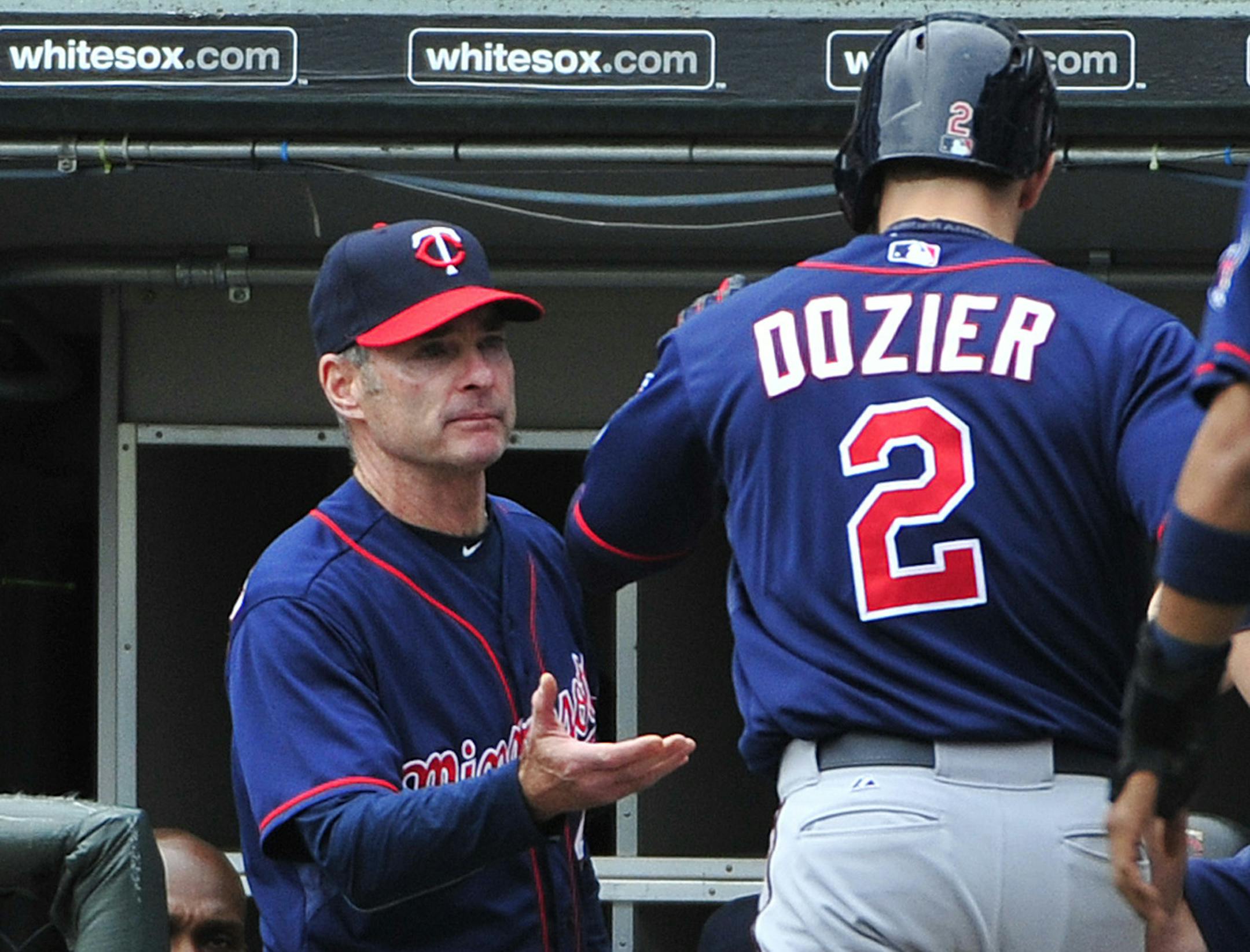 Minnesota Twins' Brian Dozier (2) is greeted by manager Paul Molitor, left after hitting a three-run homer against the Chicago White Sox during the seventh inning of a baseball game, Sunday, May 24, 2015 in Chicago. (AP Photo/David Banks)