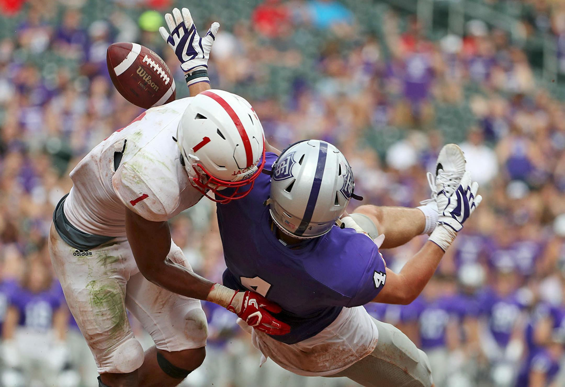 University of St. Thomas wide receiver Vinny Pallini (4) was unable to grab a long pass as St. John's University defensive back Max Jackson (1) defended in the second half.