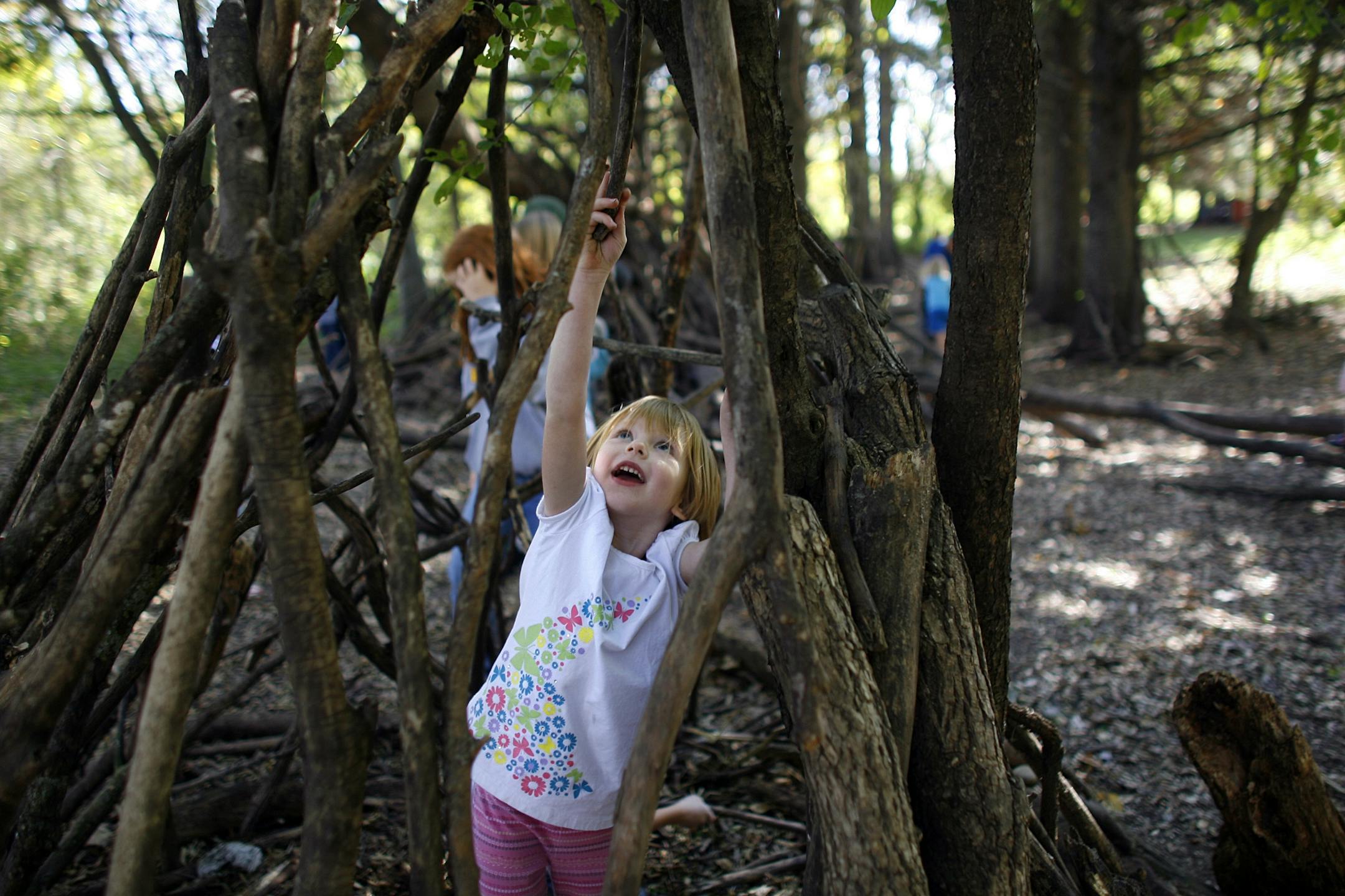Jillian Ros reached to located the perfect spot for her stick as her worked on fort during recess at Prairie Creek Community School recently. Ros had joined a fort made by fifth-graders who were happy to have little kindergartener join them. For more than 25 years, the woods surrounding Prairie Creek Community School near Northfield becomes a bustling village in the fall. Children race towards the small wooded area along the Prairie Creek at the beginning of recess each day buying and selling st