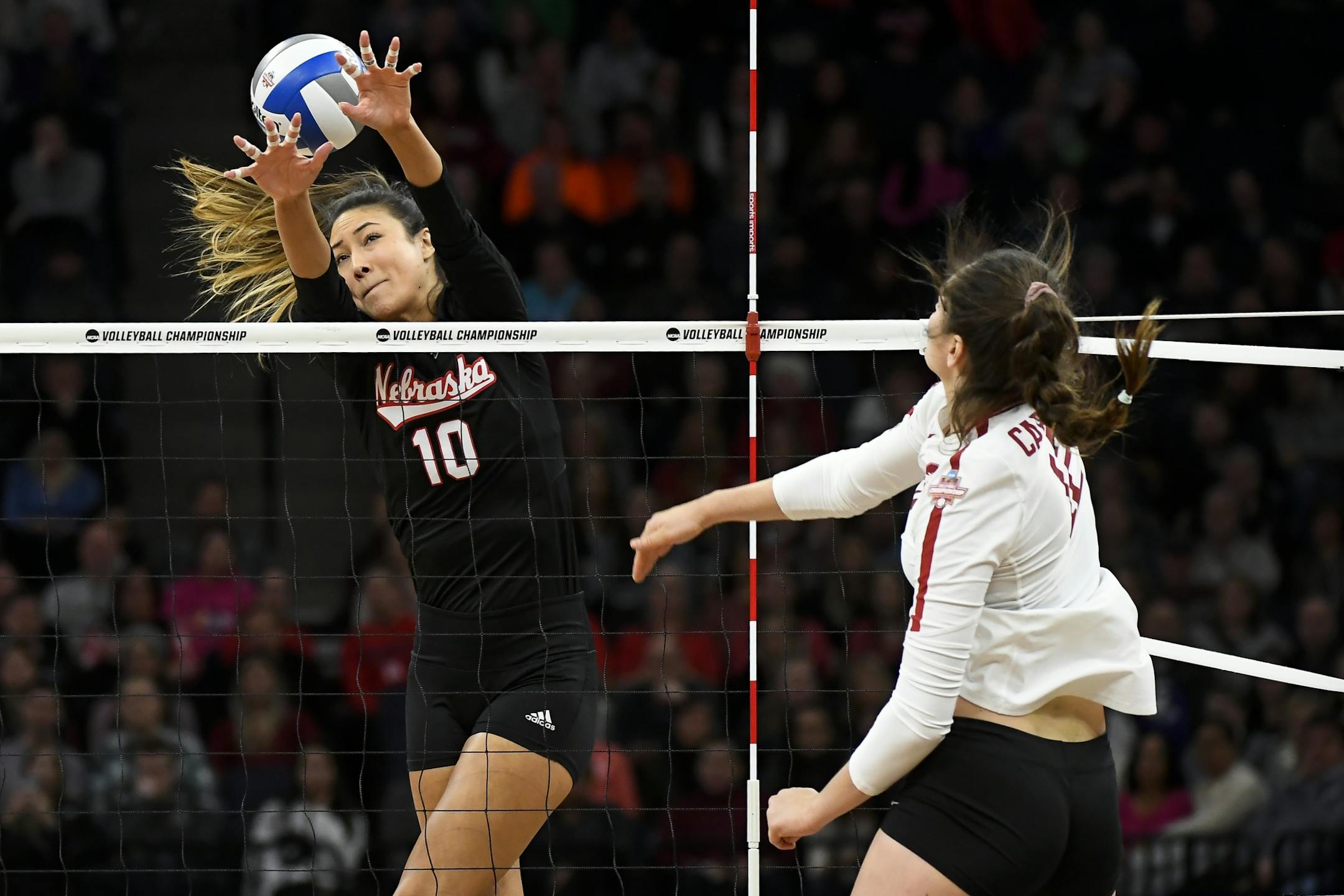 Stanford opposite Audriana Fitzmorris (12) spiked the ball past Nebraska outside hitter Lexi Sun (10) in the first set Saturday.