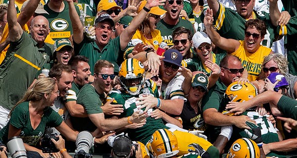 Josh Jackson celebrated with fans in the stands after returning a blocked punt for a touchdown in the first quarter.