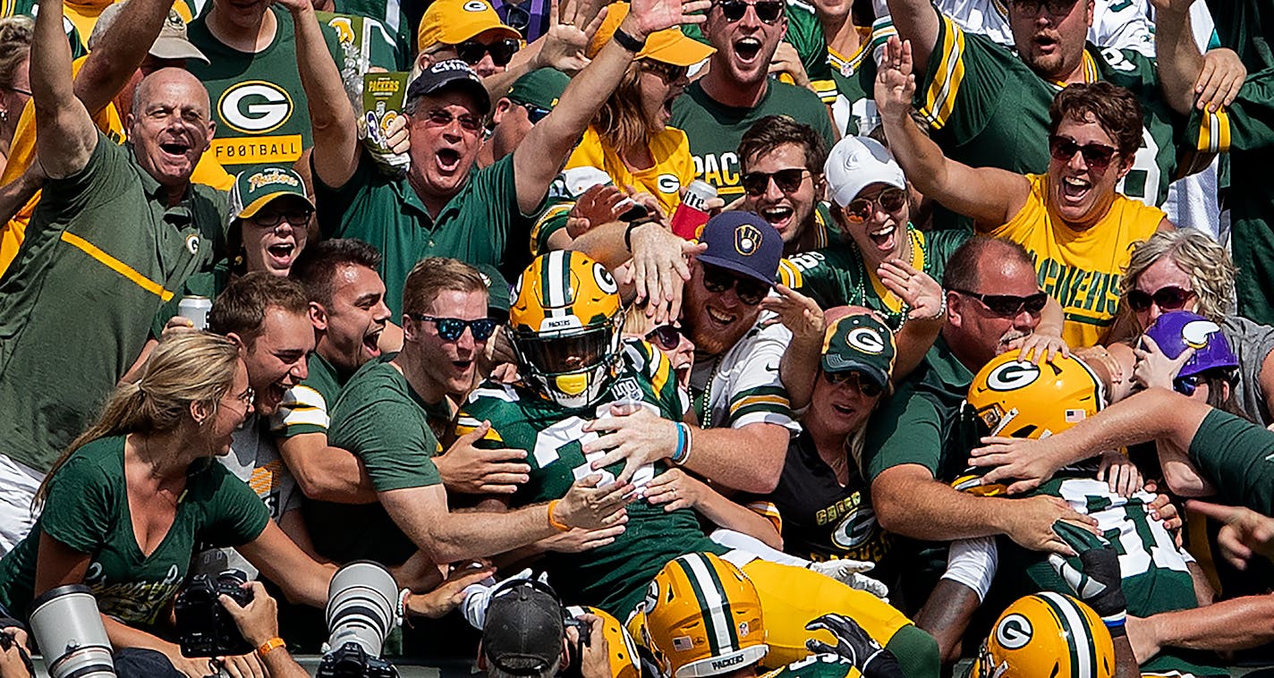 Josh Jackson celebrated with fans in the stands after returning a blocked punt for a touchdown in the first quarter.