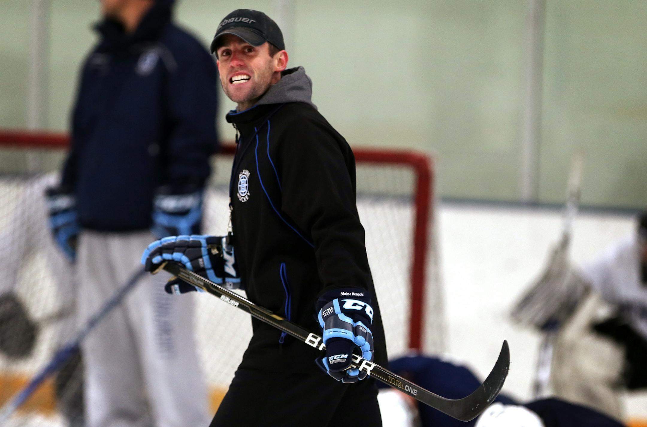 Chris Carroll, the new Blaine boys varsity hockey coach, watches players during tryouts for the team at Fogerty Arena in Blaine. ] LEILA NAVIDI leila.navidi@startribune.com /