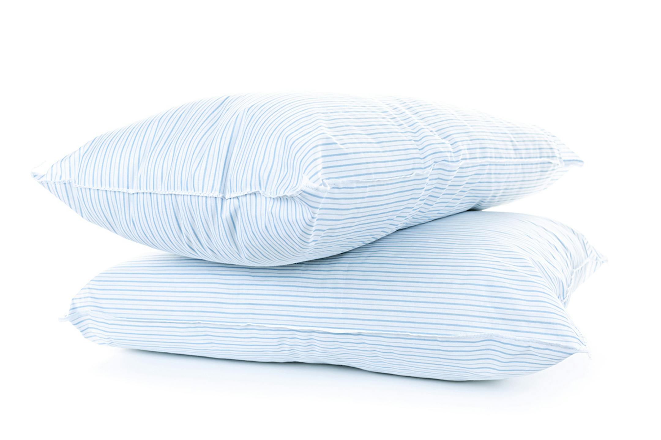 Two soft pillows with blue striped covers isolated on white background