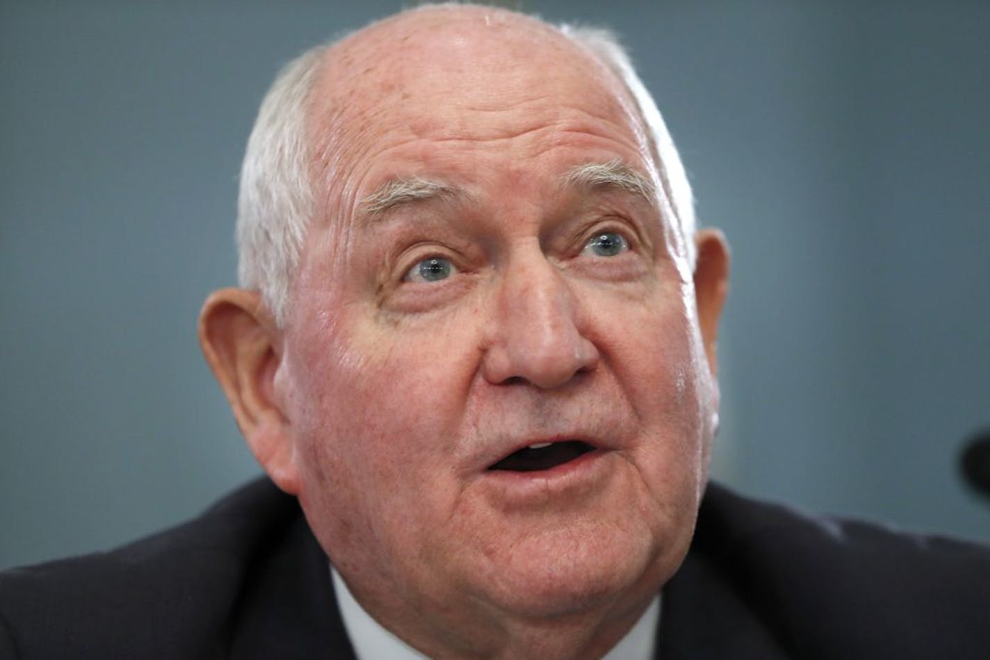 FILE - In this Feb. 27, 2019, file photo, Agriculture Secretary Sonny Perdue testifies during a House Agriculture Committee hearing on Capitol Hill in Washington. Perdue says his agency is "in the throes of constructing" an aid package for farmers hurt by retaliatory tariffs, but he could not say when it would be ready. Perdue says his agency is seeking feedback from producers about the strengths and weaknesses of last year's relief package, valued at nearly $12 billion.