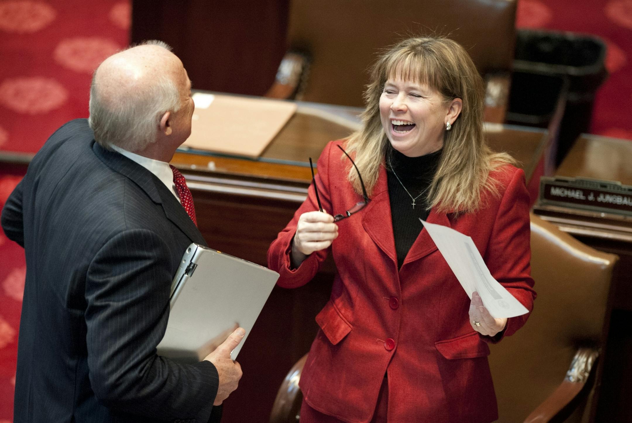 GOP Senator Mike Parry came over to GOP Senator Pam Wolf to congratulate her on the passage of her teacher tenure bill Monday, February 27, 2012. Wolf was the sponsor of the bill, which passed 36 to 26.