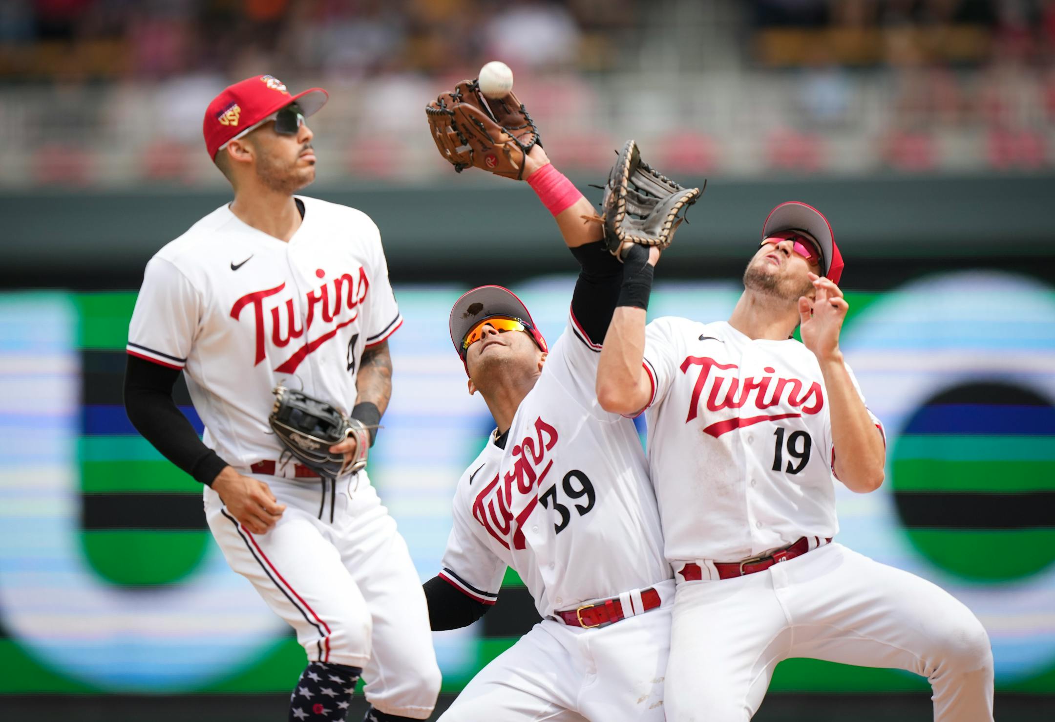 Minnesota Twins shortstop Carlos Correa (4), Minnesota Twins second baseman Donovan Solano (39) and Minnesota Twins first baseman Alex Kirilloff (19) collide as Solano catches a fly ball in the seventh inning. The Minnesota Twins defeated the Kansas City Royals 9-3 at Target Field on Tuesday, July 4, 2023 in Minneapolis.