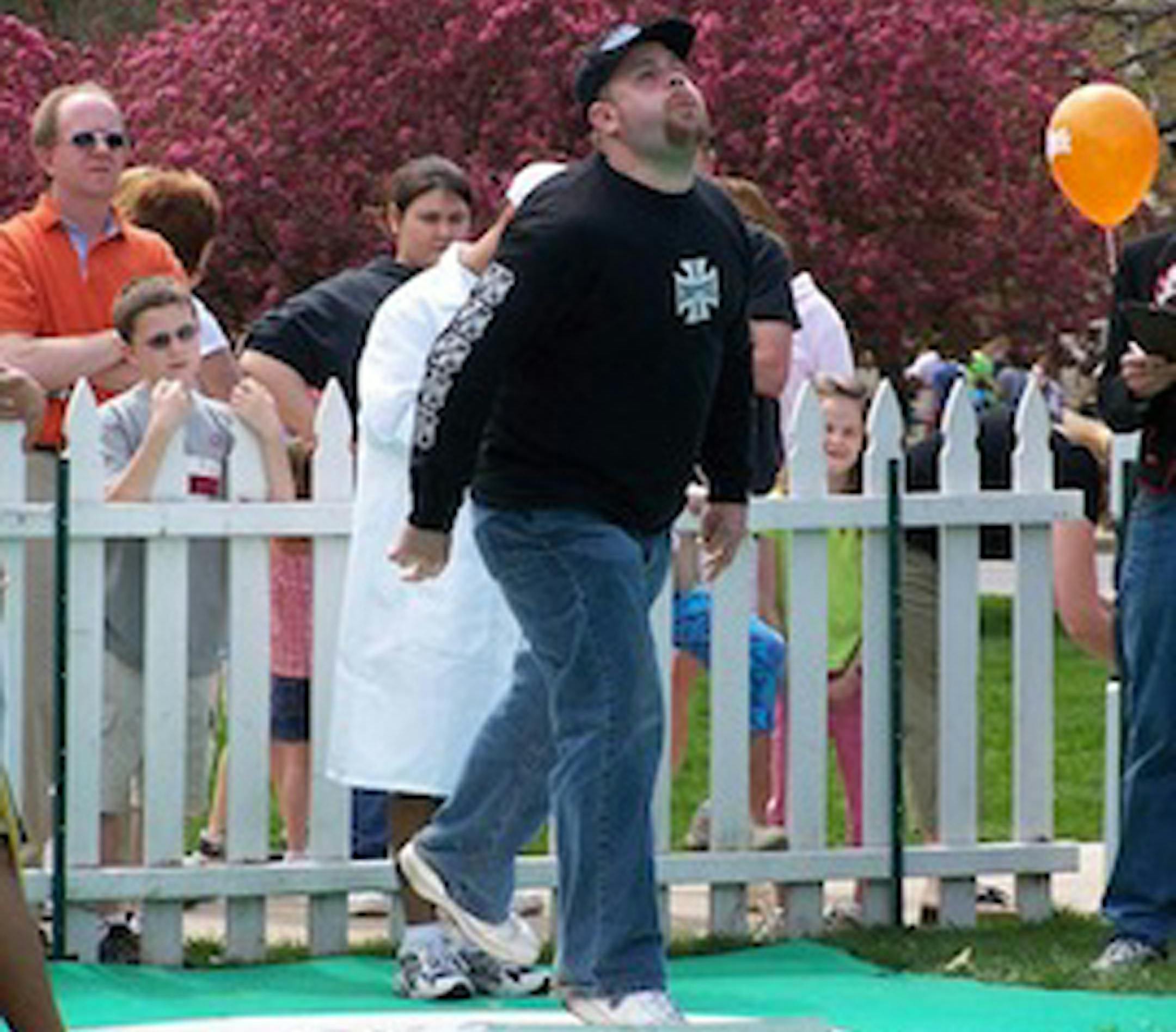 Jeff Capps, son of cricket spitting world record holder Dan Capps, tries his hand, er, mouth at the activity. (Photo courtesy of Jeff and Dan Capps)