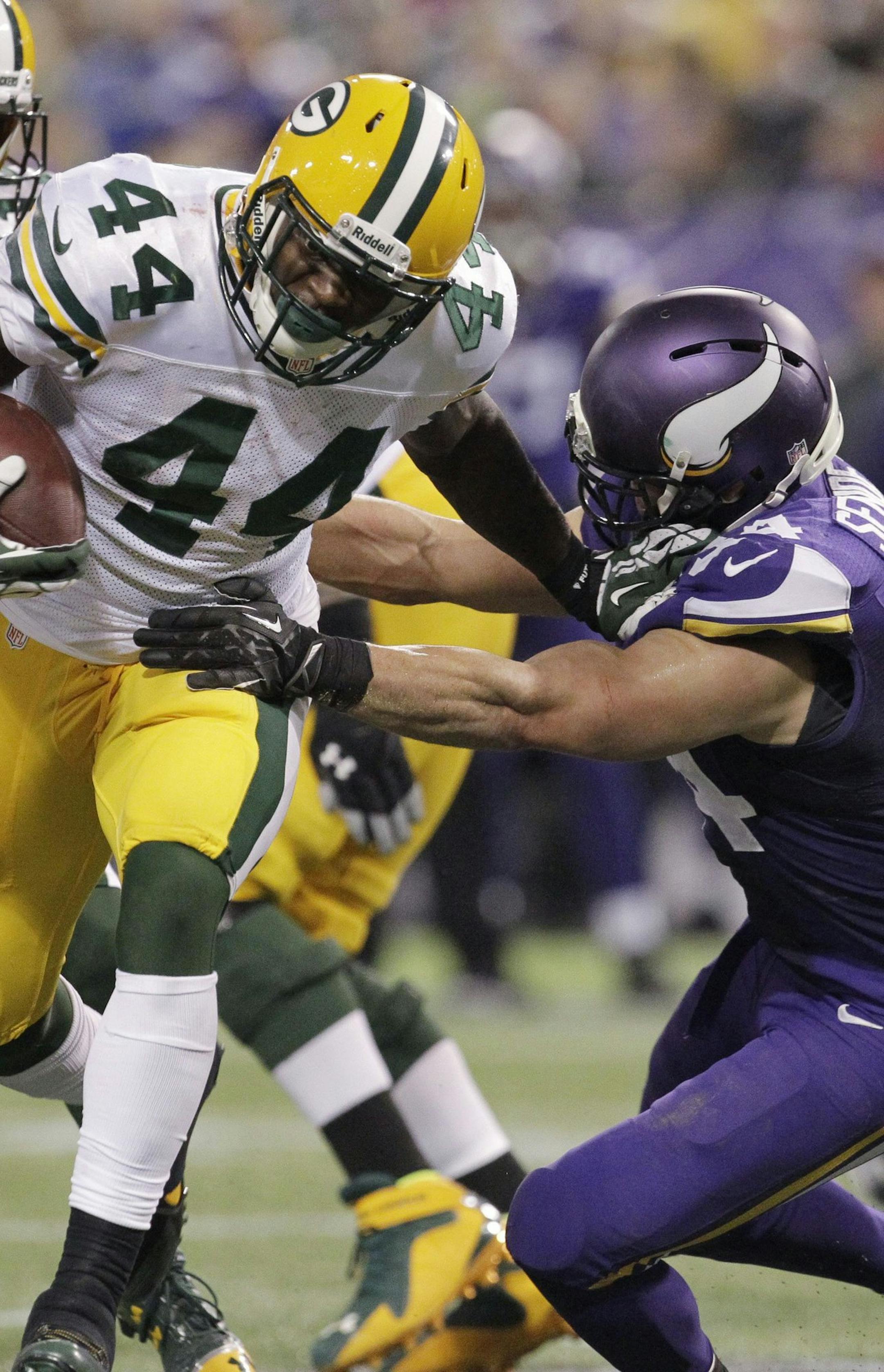 Green Bay Packers' James Starks (44) charges past Minnesota Vikings strong safety Andrew Sendejo.