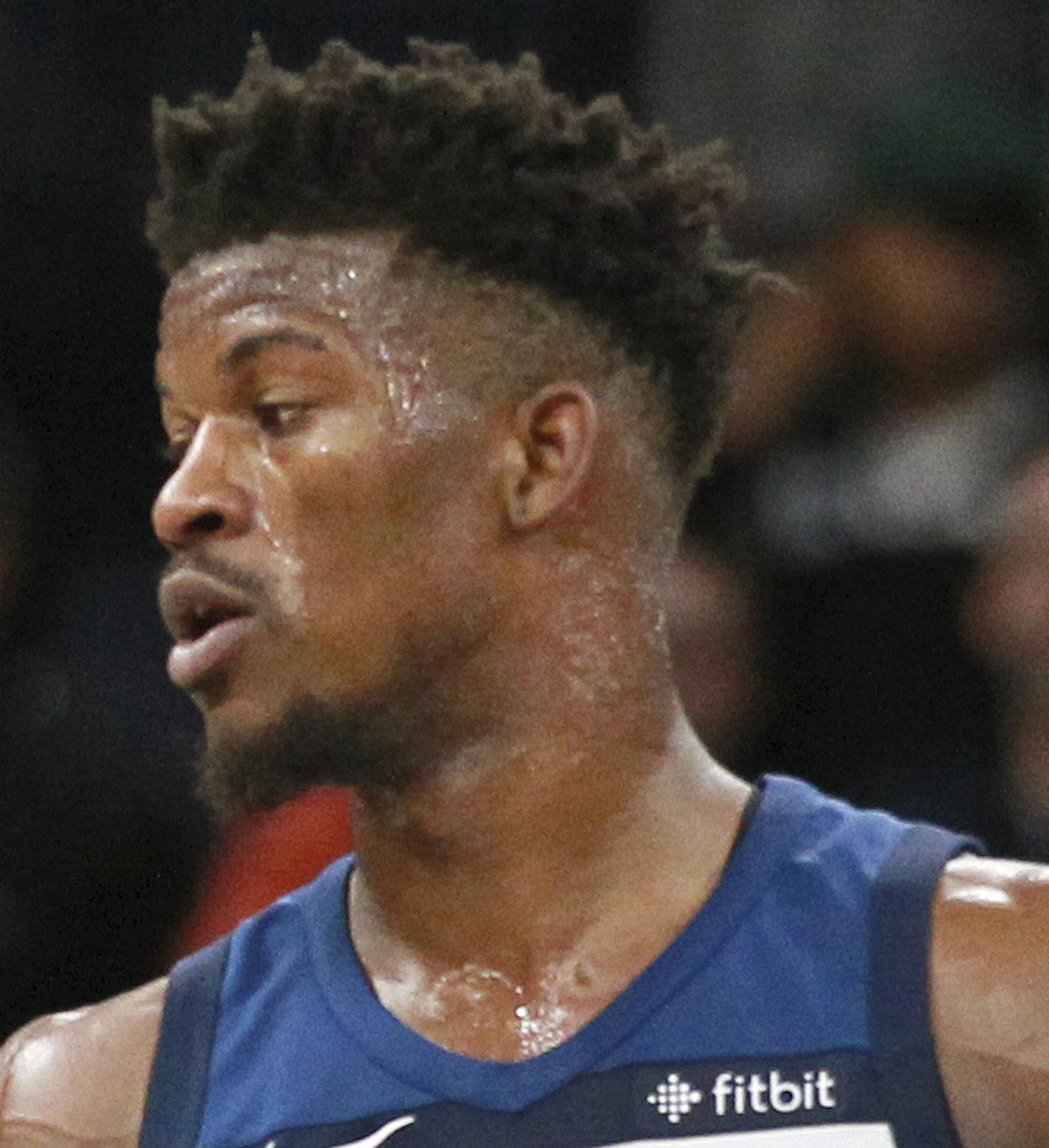 Minnesota Timberwolves forward Jimmy Butler (23) is congratulated by Timberwolves guard Andrew Wiggins (22) after scoring on the Los Angeles Clippers in the fourth quarter of an NBA basketball game on Sunday, Dec. 3, 2017, in Minneapolis. The Timberwolves defeated the Clippers 112-106. (AP Photo/Andy Clayton-King)