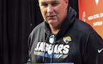 Jacksonville Jaguars head coach Doug Marrone holds letters with advice from first graders on how to beat the New England Patriots during a press confe
