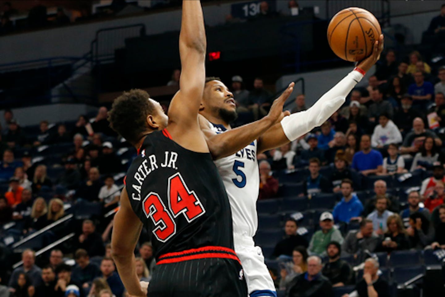 Minnesota Timberwolves' Malik Beasley, right, lays up a shot as Chicago Bulls' Wendell Carter Jr. defends in the first half of an NBA basketball game Wednesday, March 4, 2020 in Minneapolis. (AP Photo/Jim Mone)