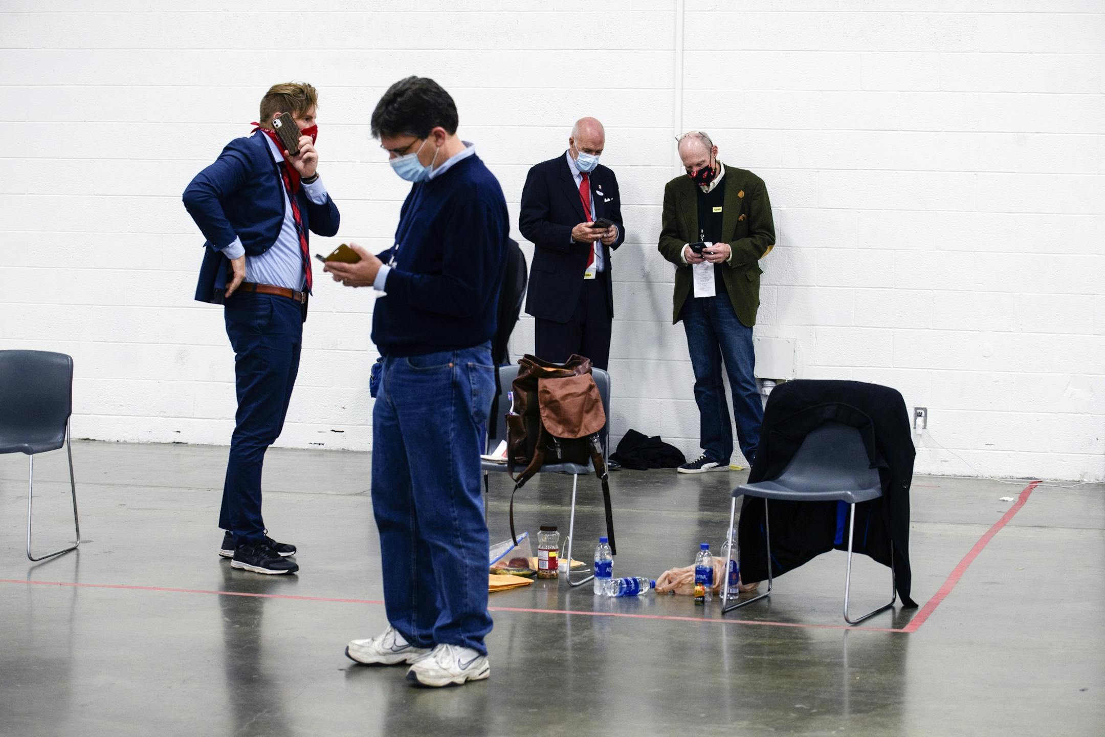 Observers make calls and check updates as the Detroit Department of Elections counts remaining absentee ballots in Detroit on Wednesday, Nov. 4, 2020. Dawn broke over the United States with the presidential election undecided and the specter of hours or even days of uncertainty ahead.