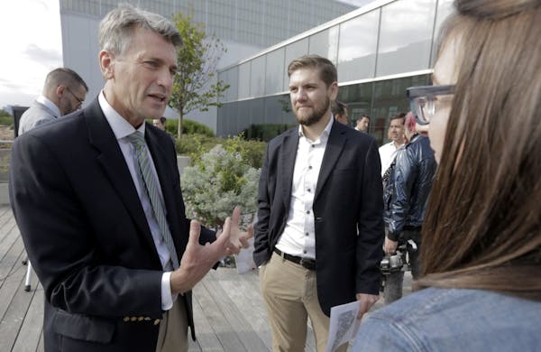 Minneapolis Mayor R.T. Rybak, left, who recently married 46 same-sex couples following his state's passage of a law legalizing gay weddings, speaks wi