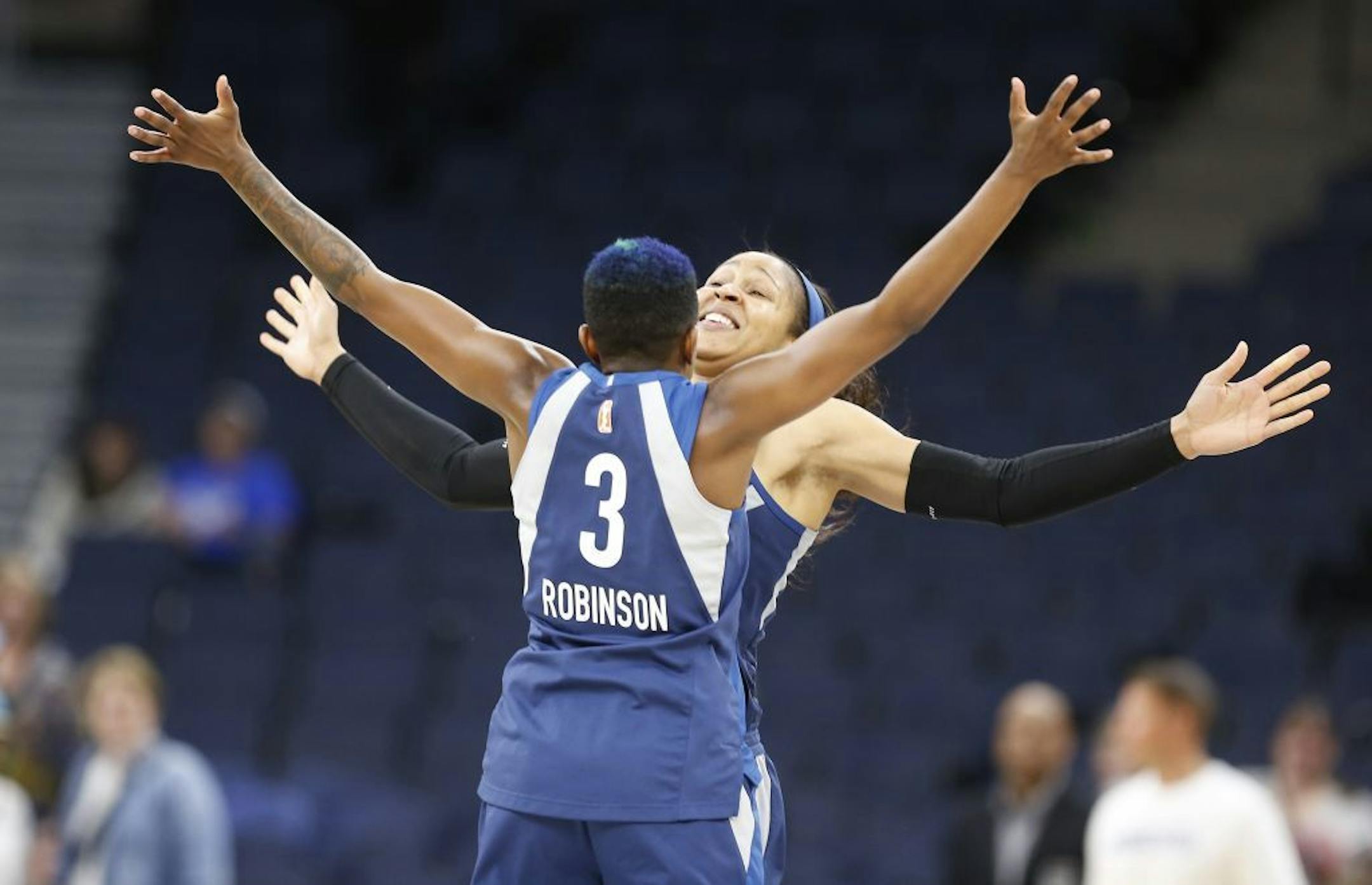 Minnesota Lynx forward Maya Moore (23) and Minnesota Lynx guard Danielle Robinson (3) do a special chest bump cheer at the end of a game earlier this season.