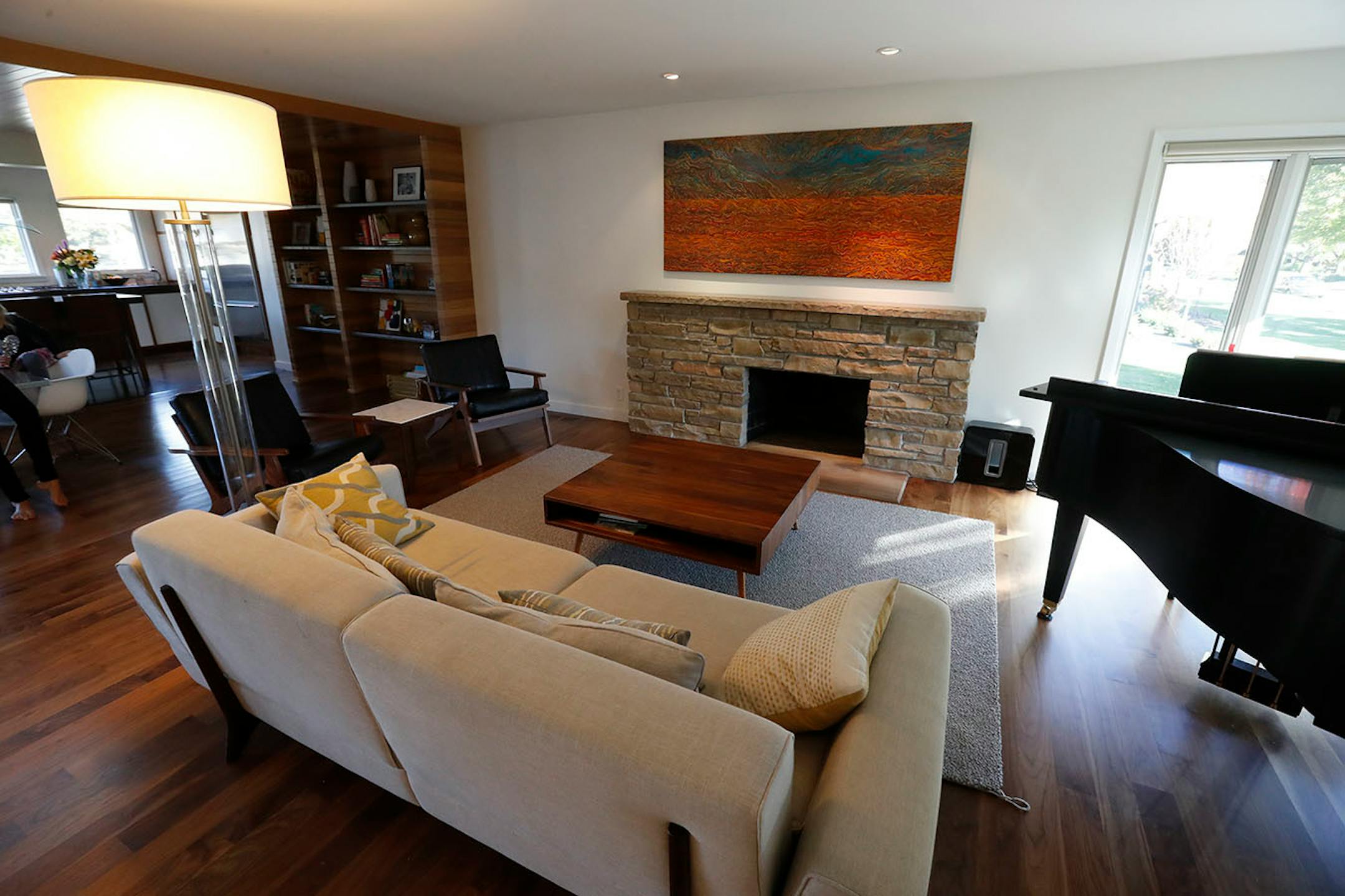 A painting by local artist Leon Hushcha adds vibrant color above the original Kasota stone fireplace.