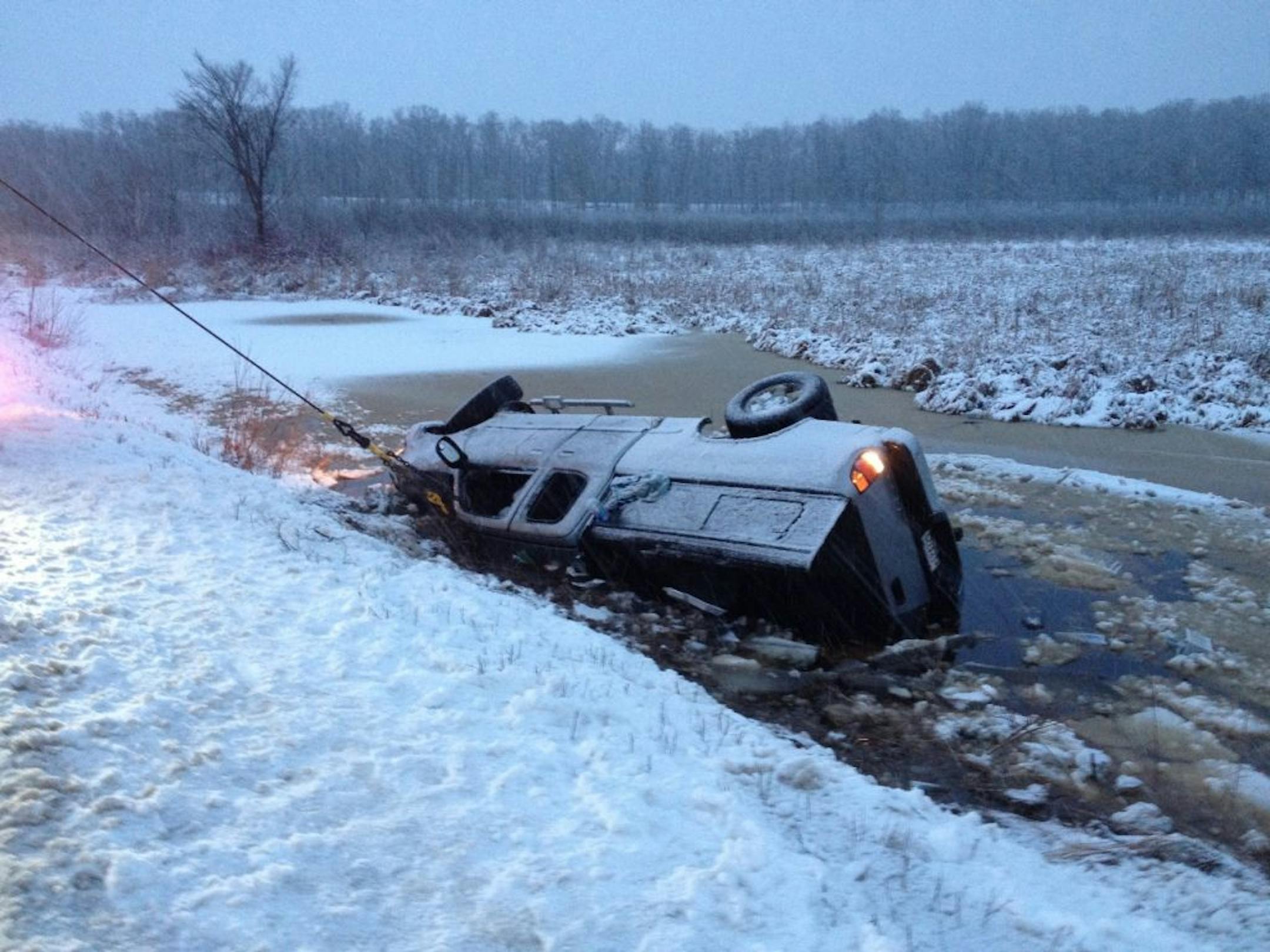 Passersby in western Wisconsin saved the lives of a 19-year-old woman, her infant son and a teenager who were in a pickup truck that slid down an embankment and landed upside-down in an icy river, authorities said Monday.