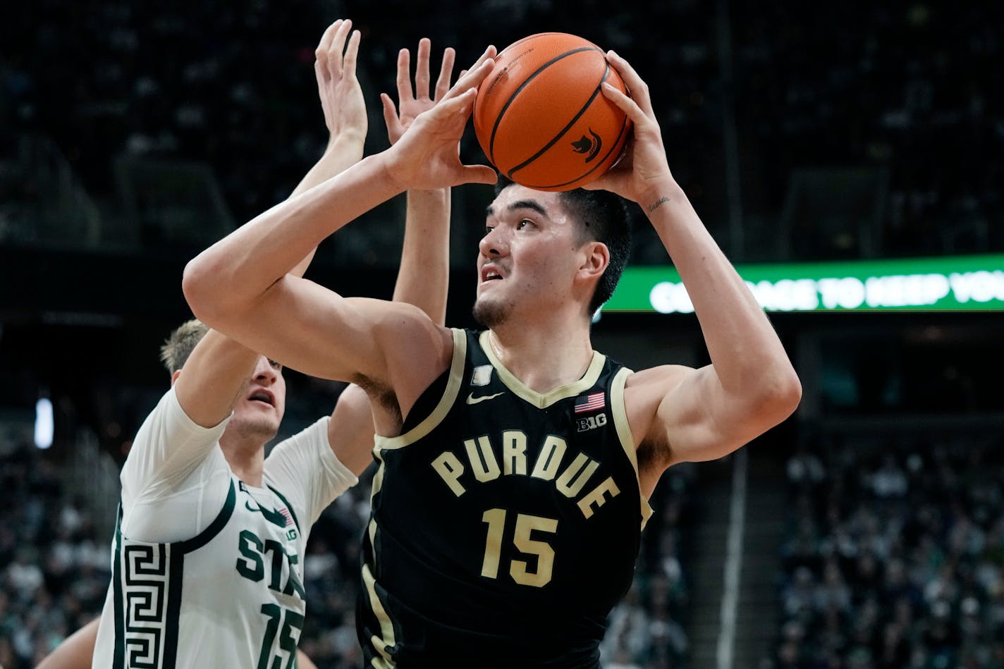 Purdue center Zach Edey (15) attempts a shot as Michigan State center Carson Cooper (15) defends during the first half of an NCAA college basketball game, Monday, Jan. 16, 2023, in East Lansing, Mich. (AP Photo/Carlos Osorio)