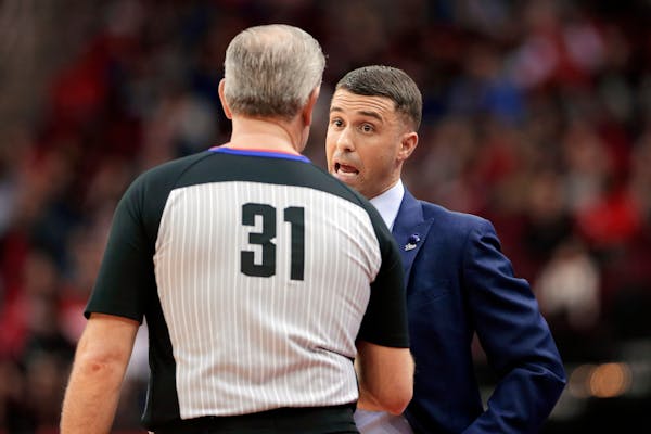 Timberwolves head coach Ryan Saunders, right, talks with referee Scott Wall during a game against the Rockets on Jan. 11.