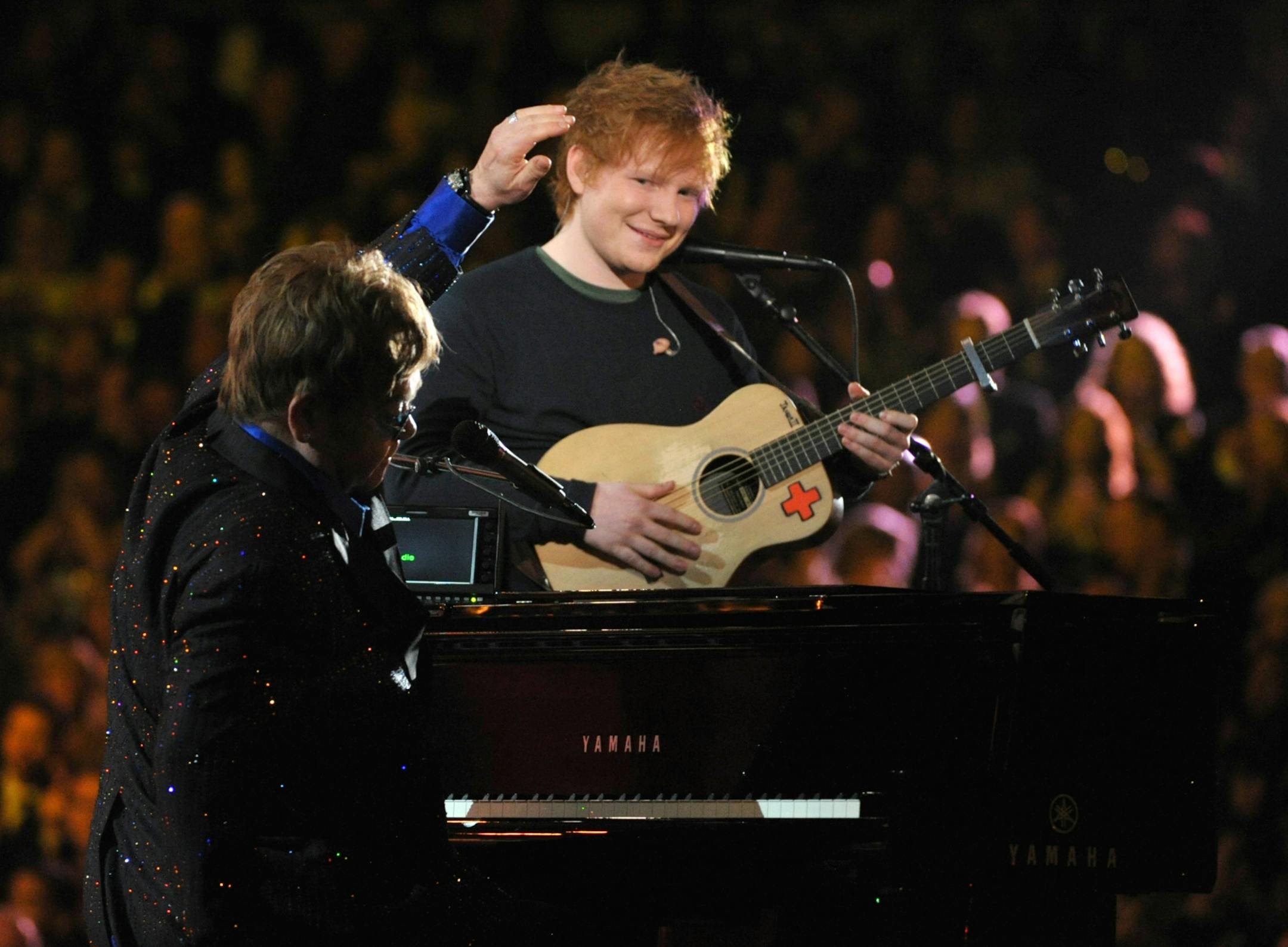 Sir Elton John, left, and Ed Sheeran perform on stage at the 55th annual Grammy Awards on Sunday, Feb. 10, 2013, in Los Angeles.