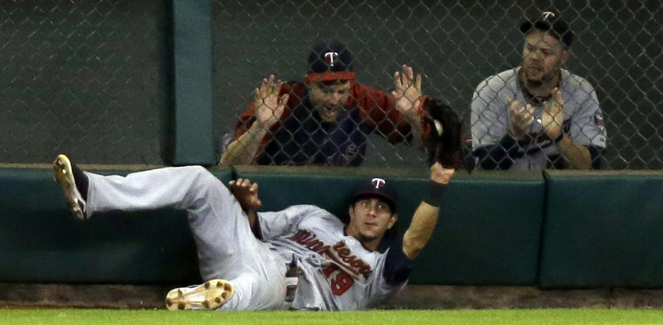 Minnesota Twins' Darin Mastroianni (19) holds up the ball after making a leaping catch on a fly ball hit by Houston Astros' Jose Altuve during the fourth inning of a baseball game Tuesday, Sept. 3, 2013, in Houston. (AP Photo/David J. Phillip)