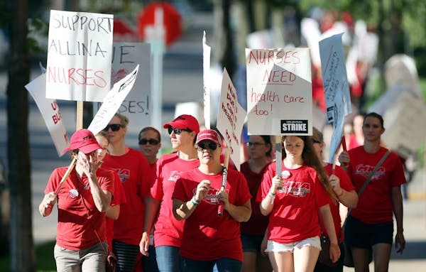 Thousands of nurses walked around Abbott Northwestern Hospital during a June strike. Allina Health hospital nurses voted late Thursday to call for a s