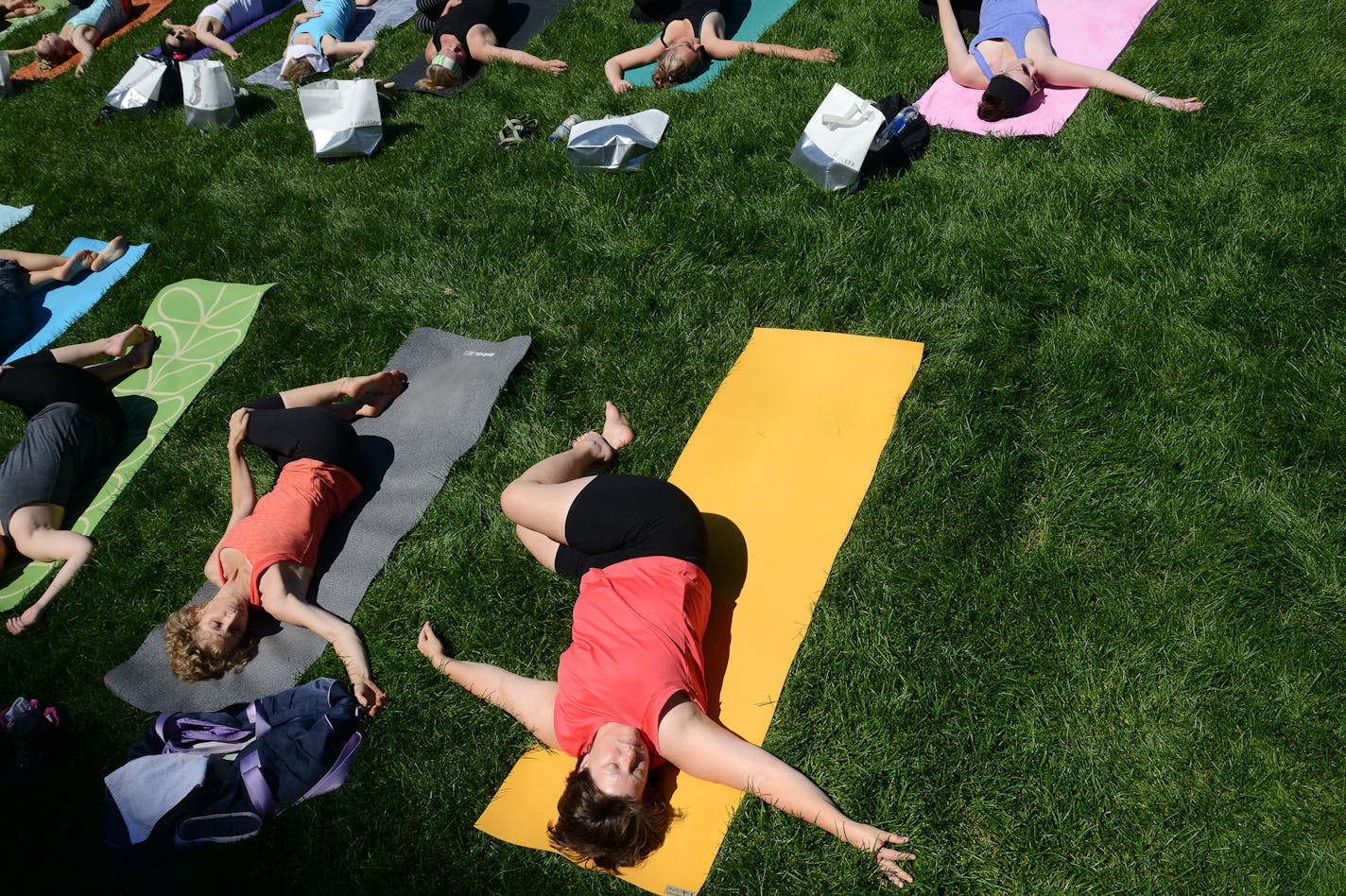 People stretched out during Yoga Camp's free outdoor yoga event on International Yoga Day in Minneapolis, Minn., on Sunday June 21, 2015. Yoga Camp is new this year, and continues from the summer solstice to the autumn equinox. ] RACHEL WOOLF &#x2211; rachel.woolf@startribune.com