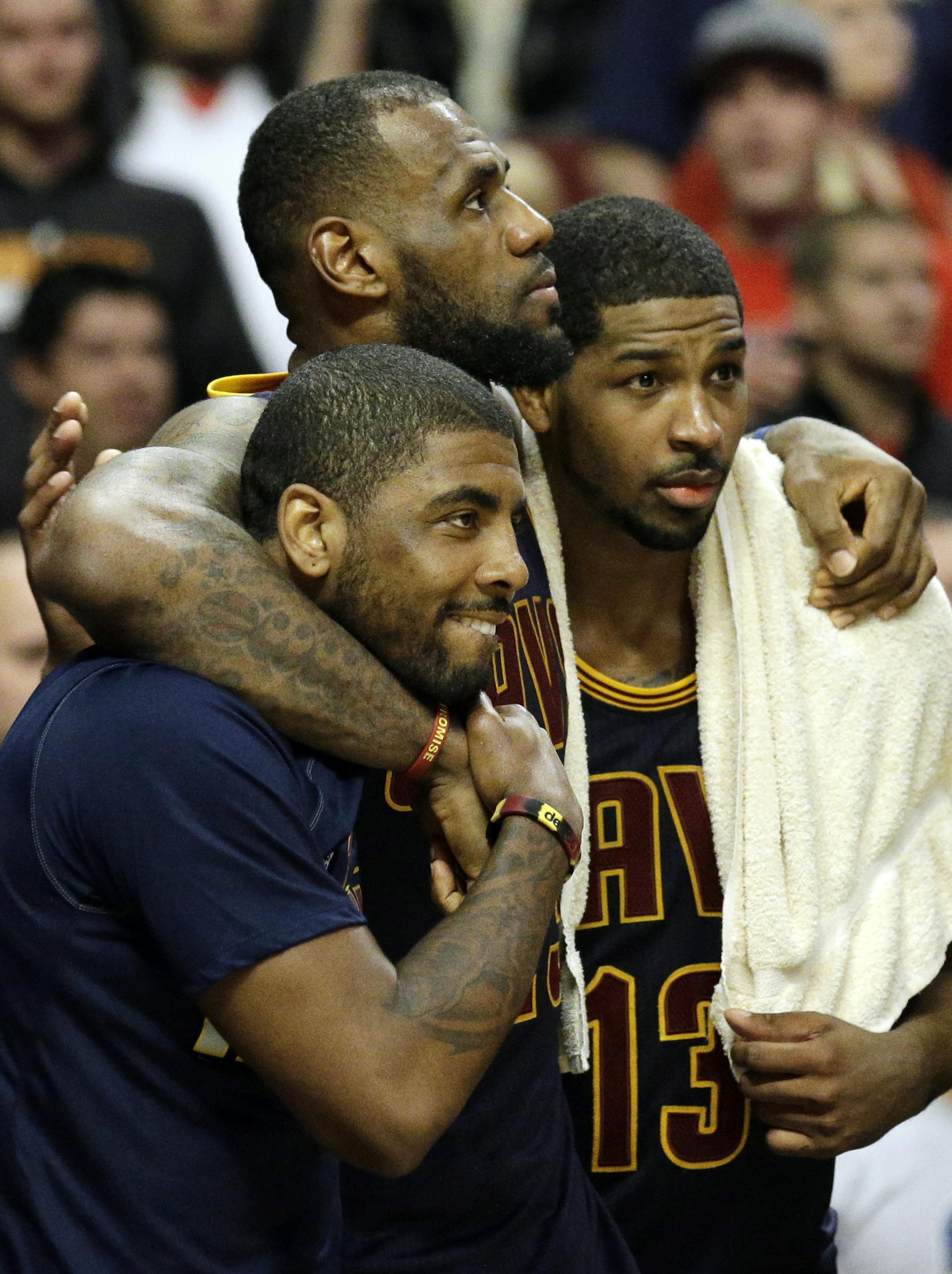 Cleveland Cavaliers forward LeBron James, center, watches the end of the game against the Chicago Bulls with guard Kyrie Irving, left, and center Tristan Thompson during the second half of Game 6 in a second-round NBA basketball playoff series in Chicago on Thursday, May 14, 2015. The Cavaliers won 94-73. (AP Photo/Nam Y. Huh)