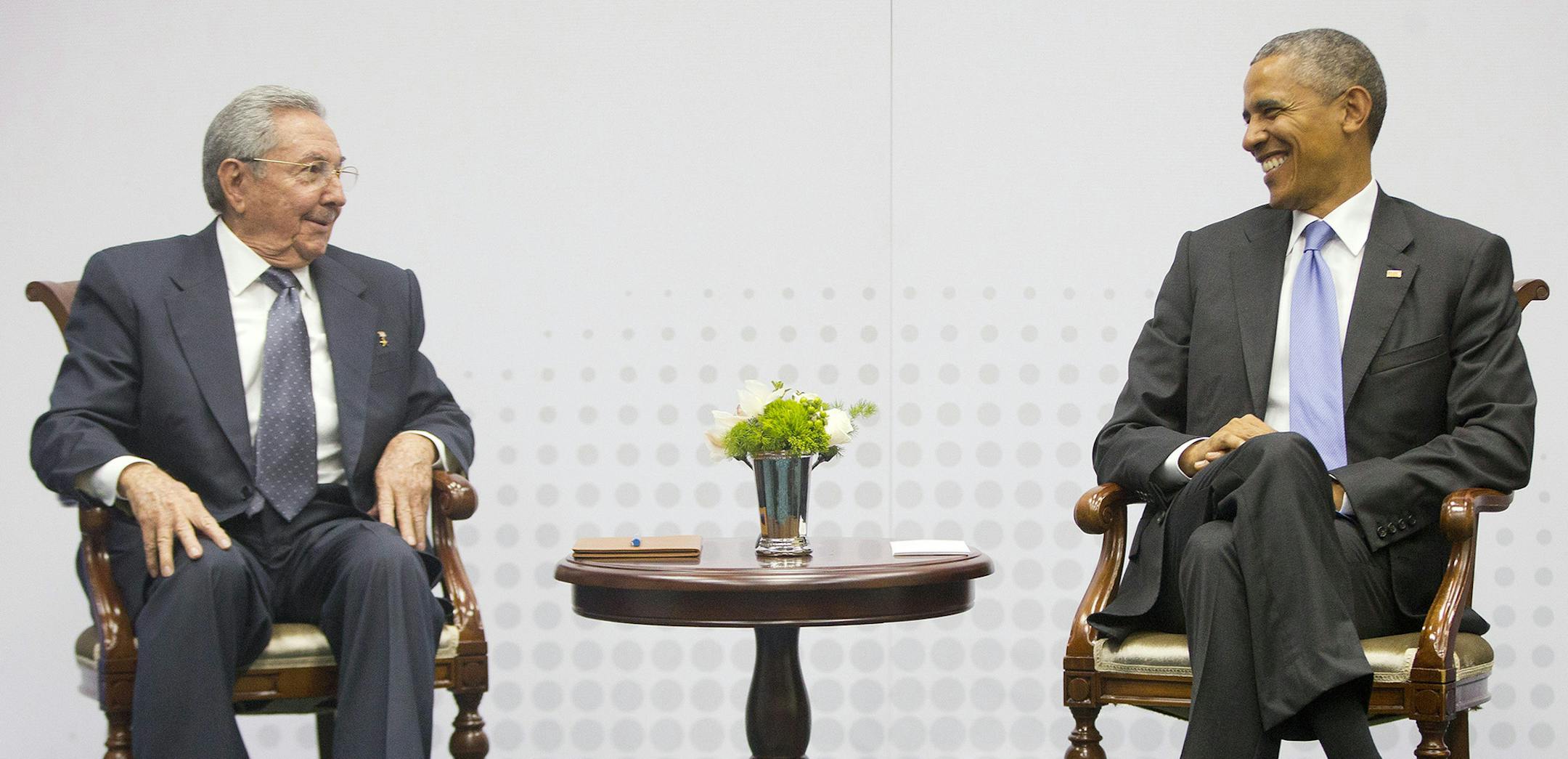 In this Saturday, April 11, 2015 photo, U.S. President Barack Obama, right, smiles as he looks over towards Cuban President Raul Castro, left, during their historic meeting, at the Summit of the Americas in Panama City, Panama. The leaders of the United States and Cuba held their first formal meeting in more than half a century on Saturday, clearing the way for a normalization of relations that had seemed unthinkable to both Cubans and Americans for generations. (AP Photo/Pablo Martinez Monsivai