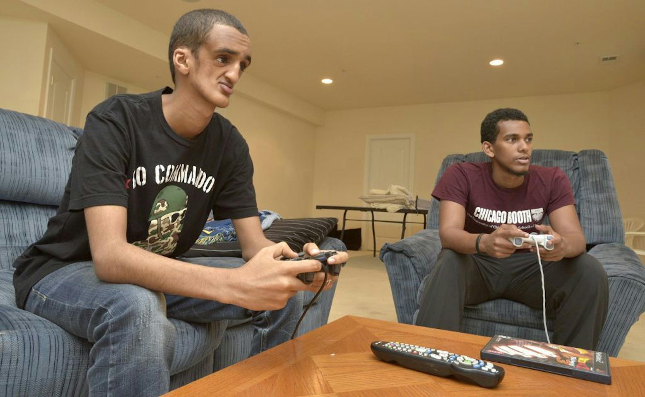 Filmon Haile, from Asmara, the capital city of Eritrea, in east Africa, left, plays a video game with Matt Michael, at his home on July 30, 2015 in Bowie, Md.