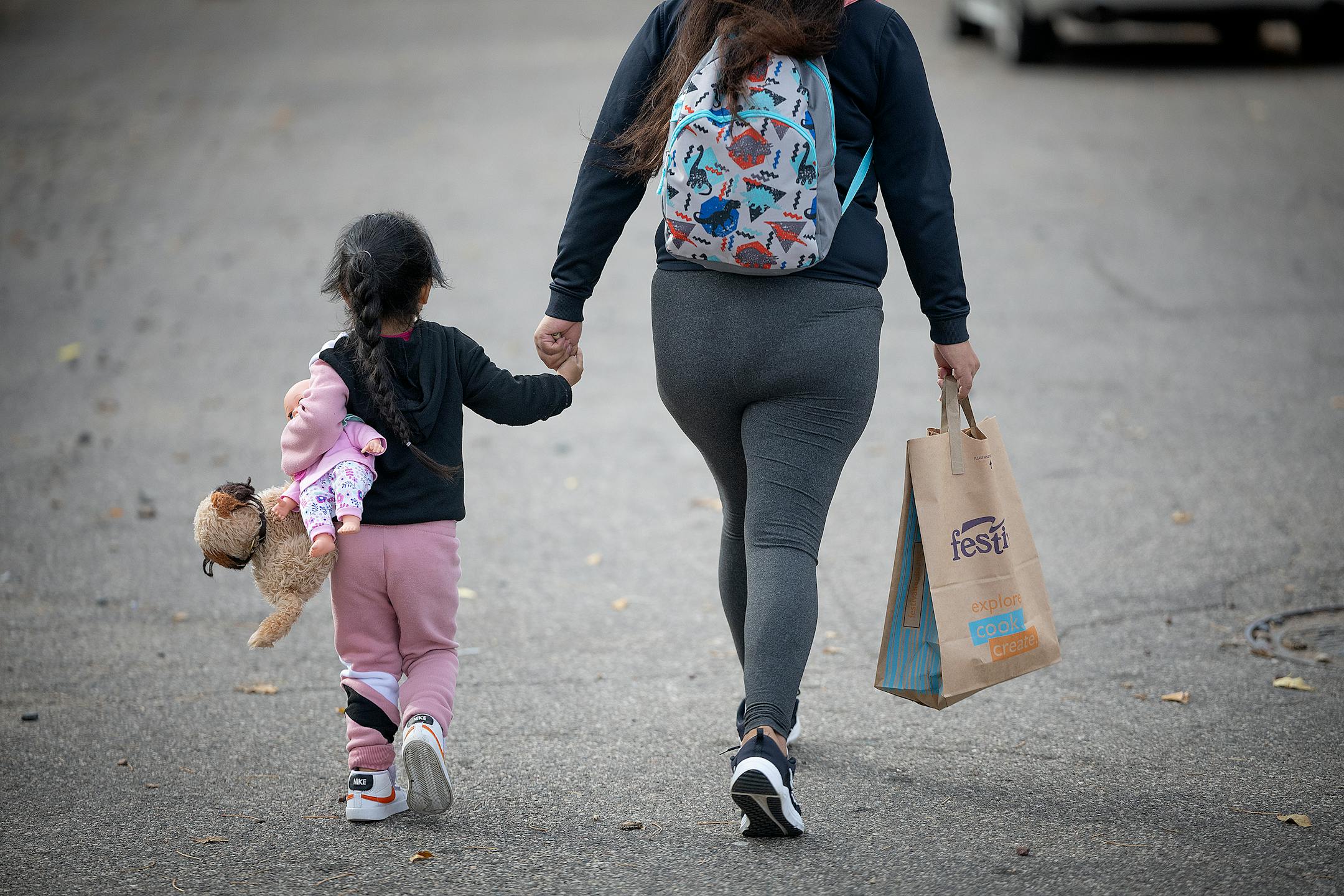 A woman and her daughter make their way to a homeless family shelter in Bloomington.