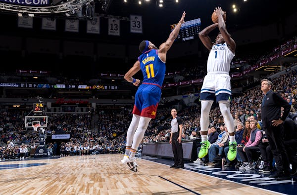 Anthony Edwards (1) of the Minnesota Timberwolves attempts a shot while defended by Bruce Brown (11) of the Denver Nuggets Monday, January 2, 2023, at