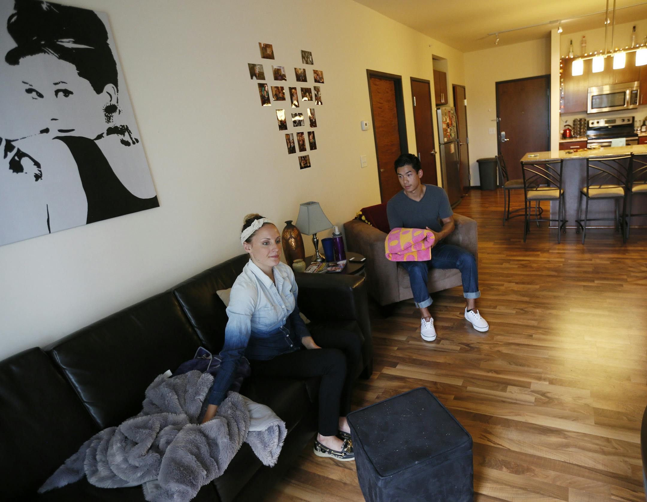 Ashley Gilles left and her friend Chris LaCourciere folded towels at her apartment near the University of MinnesotaThursday June, 6, 2013 in Minneapolis MN. ] JERRY HOLT ‚Ä¢ jerry.holt@startribune.com