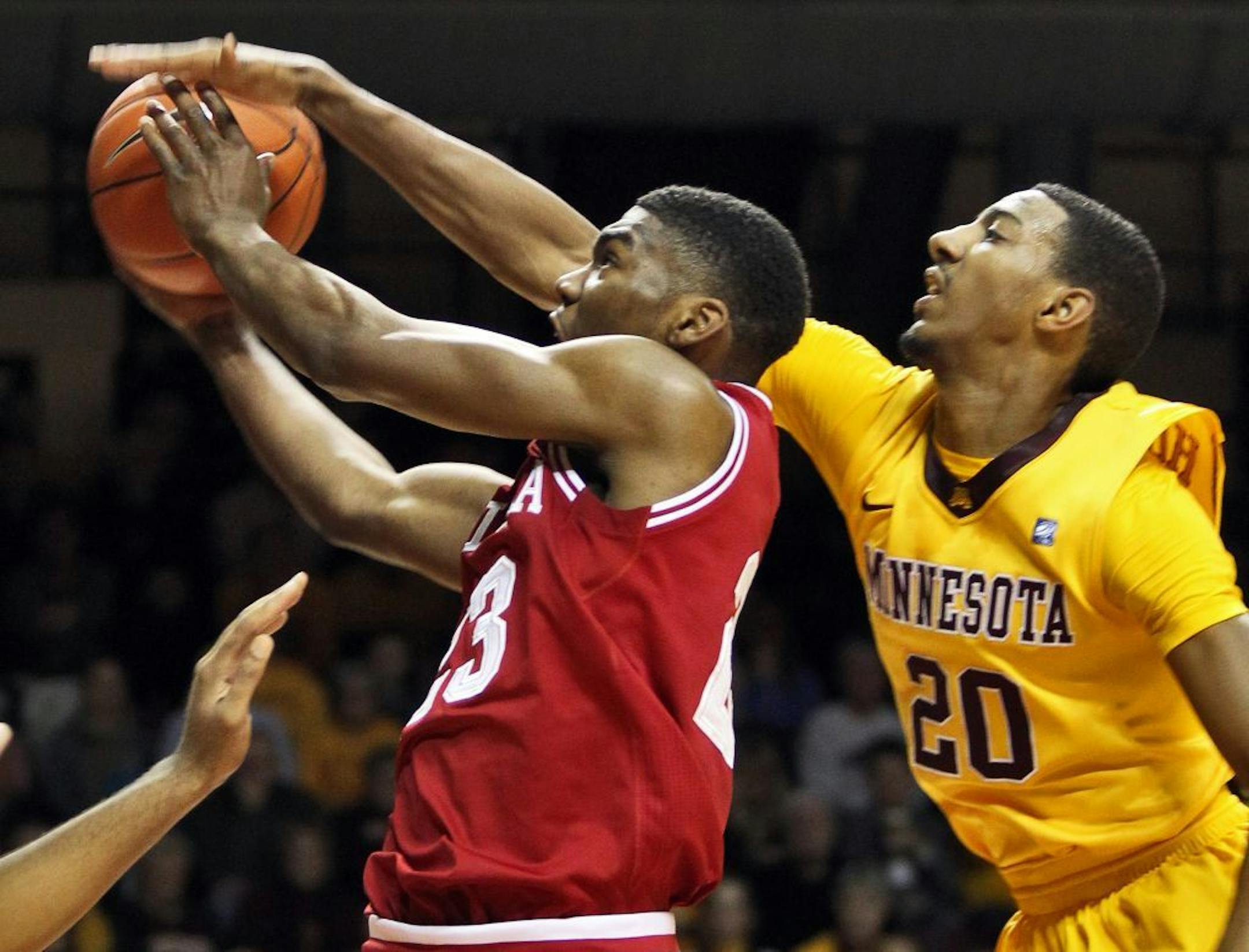 Minnesota Gophers vs. Indiana Hoosiers basketball. Indiana's Remy Abell was fouled by Gophers Austin Hollins (20) as Abell drove to the basket for a layup.