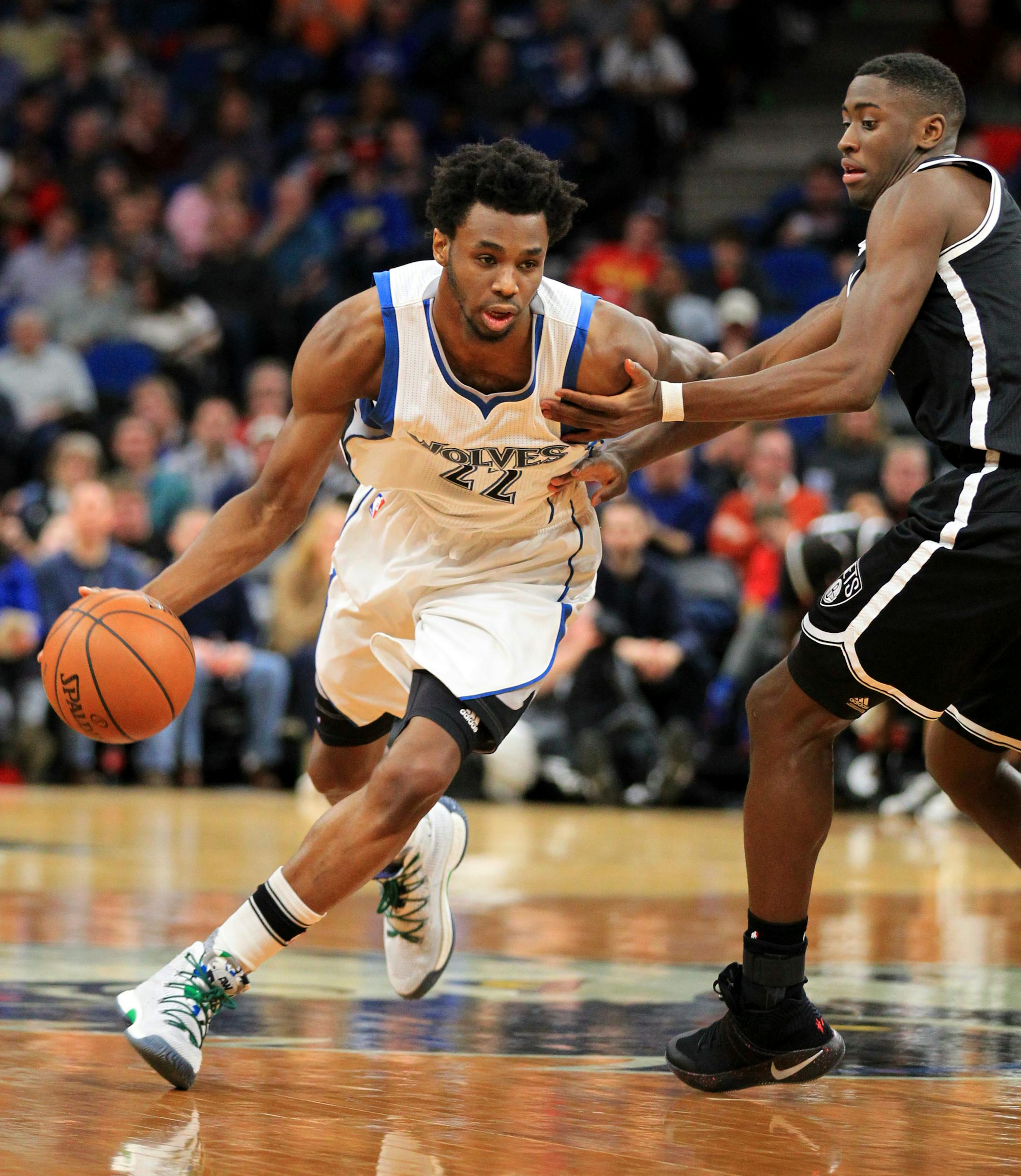 Minnesota Timberwolves guard Andrew Wiggins (22) drives on Brooklyn Nets guard Caris LeVert (22) during the third quarter of an NBA basketball in Minneapolis, Saturday, Jan. 28, 2017. The Timberwolves defeated the Nets 129-109. (AP Photo/Andy Clayton-King)