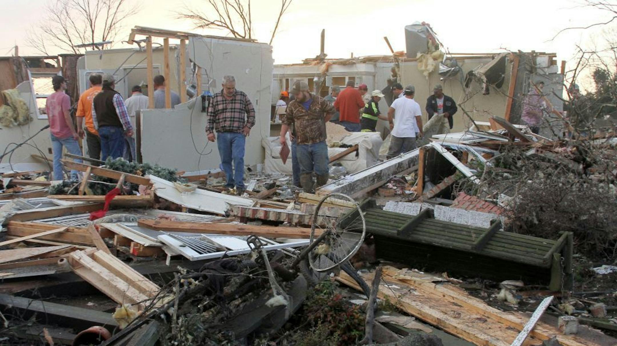 People inspect a storm-damaged home in the Roundaway community near Clarksdale, Miss., Wednesday, Dec. 23, 2015. A storm system forecasters called "particularly dangerous" killed multiple people as it swept across the country Wednesday.