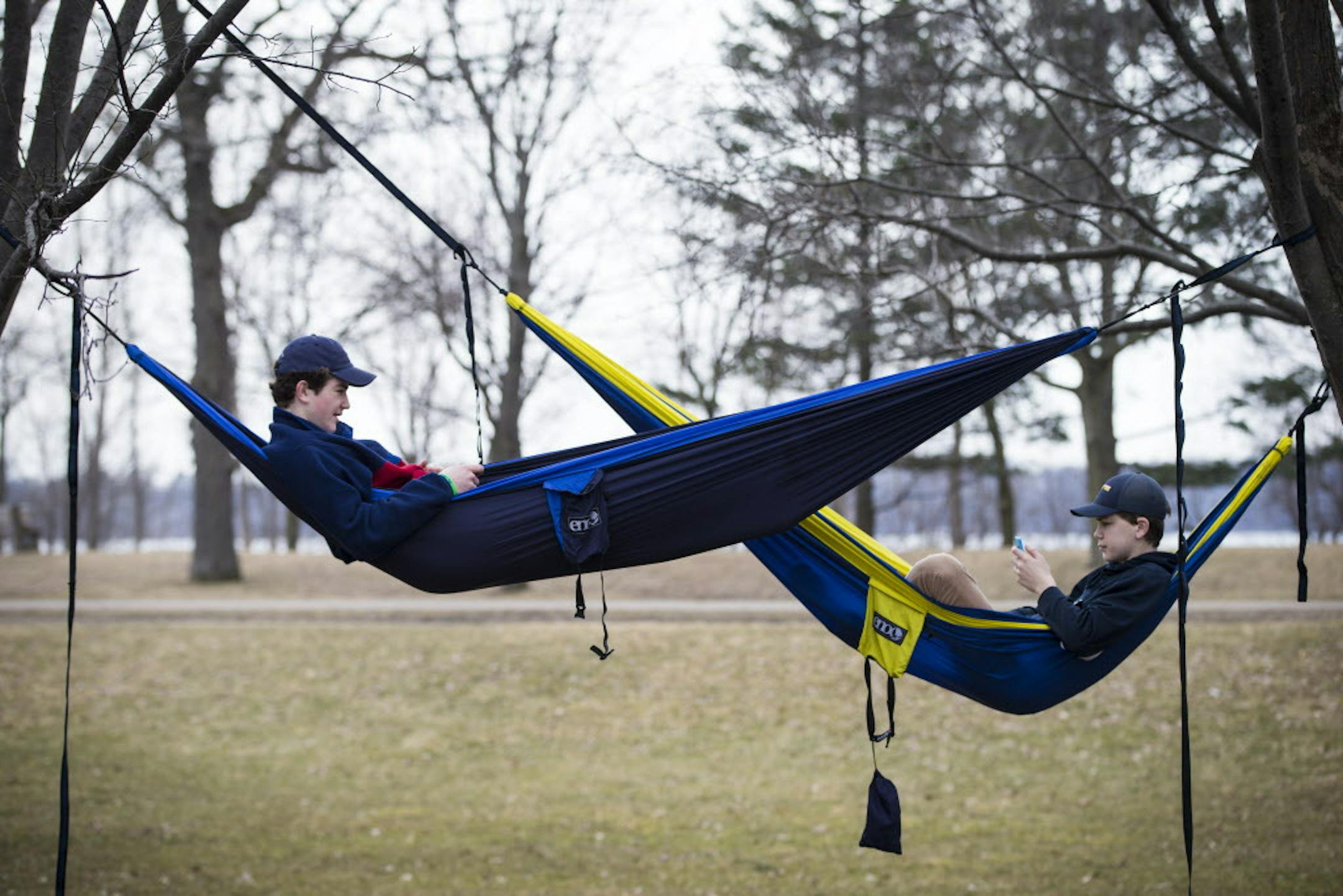 From left to right; Henry Bitter, 15 and Thor Holien, 15, chatted while hanging in their hammocks they hung at the rose garden at Lake Harriet on they're day off from school after finishing finals last week at Holy Angels, on Monday, March 7, 2016, in Minneapolis, Minn. ] RENEE JONES SCHNEIDER &#x2022; reneejones@startribune.com