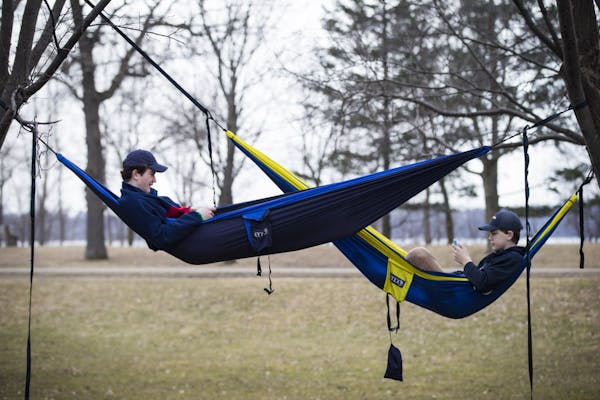 From left to right; Henry Bitter, 15 and Thor Holien, 15, chatted while hanging in their hammocks they hung at the rose garden at Lake Harriet on they