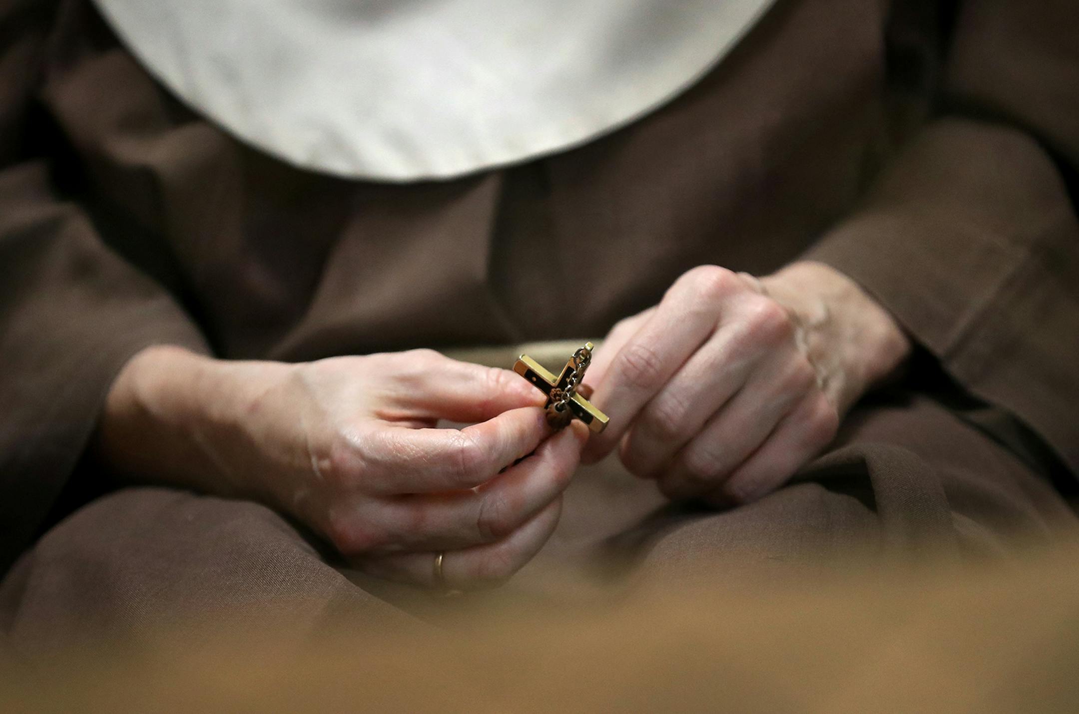 Poor Clare nuns of St. Clare's Monastery nuns met with journalists in the monastery's parlor, the one room where outsiders have partial access to the nuns in a room divided by a metal fencing with a folding wooden divider and seen Thursday, April 16, 2020, in Sauk Rapids, MN. Among the Nun Sister Marie Elizabeth holds a small cross.