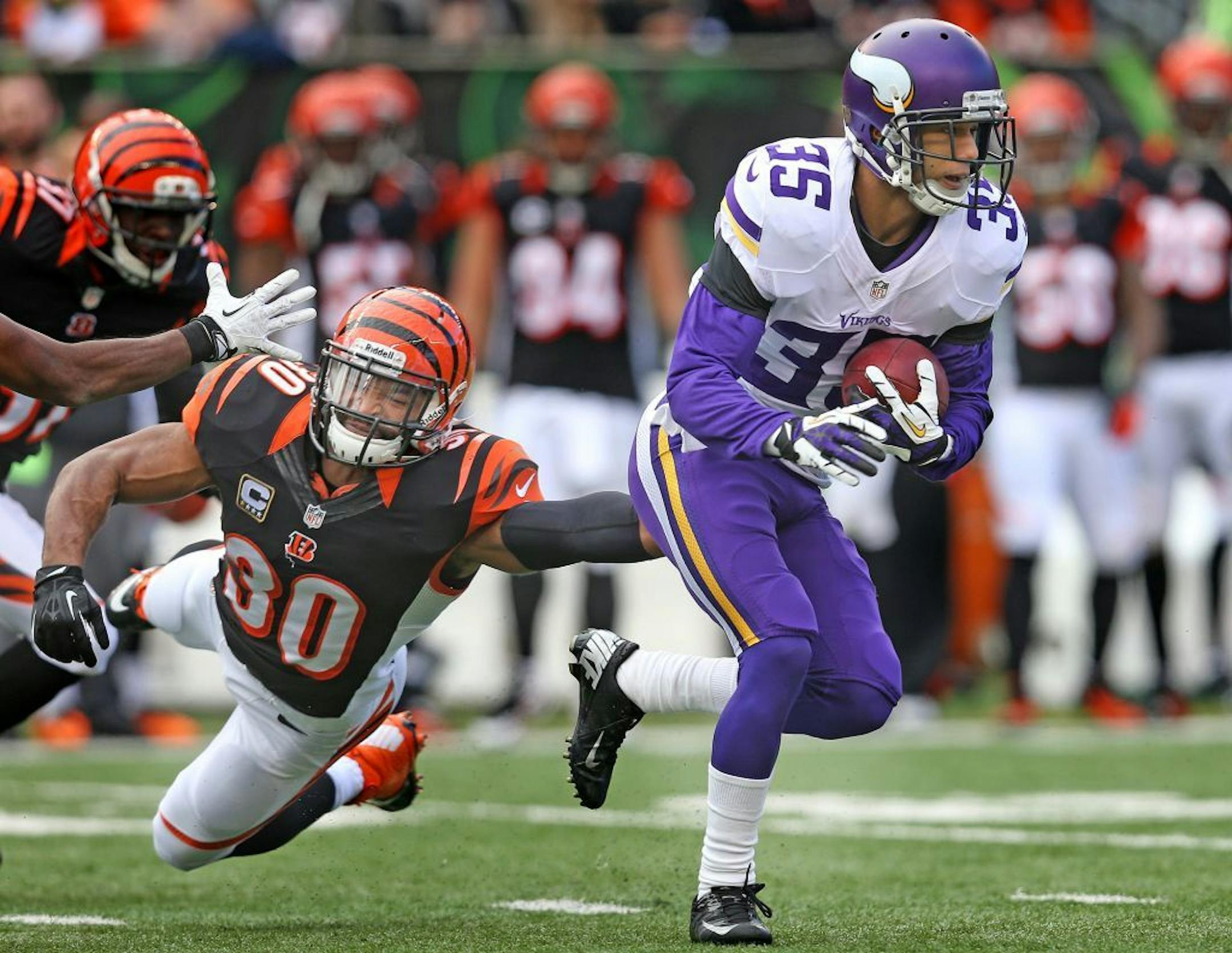 Minnesota Vikings cornerback Marcus Sherels (35) was tackled by Cincinnati Bengals running back Cedric Peerman (30) in the first quarter as the Minnesota Vikings took on the Cincinnati Bengals at Paul Brown Stadium in Cincinnati, OH, Sunday, December 22, 2013. ELIZABETH FLORES/STAR TRIBUNE) ELIZABETH FLORES � eflores@startribune.com
