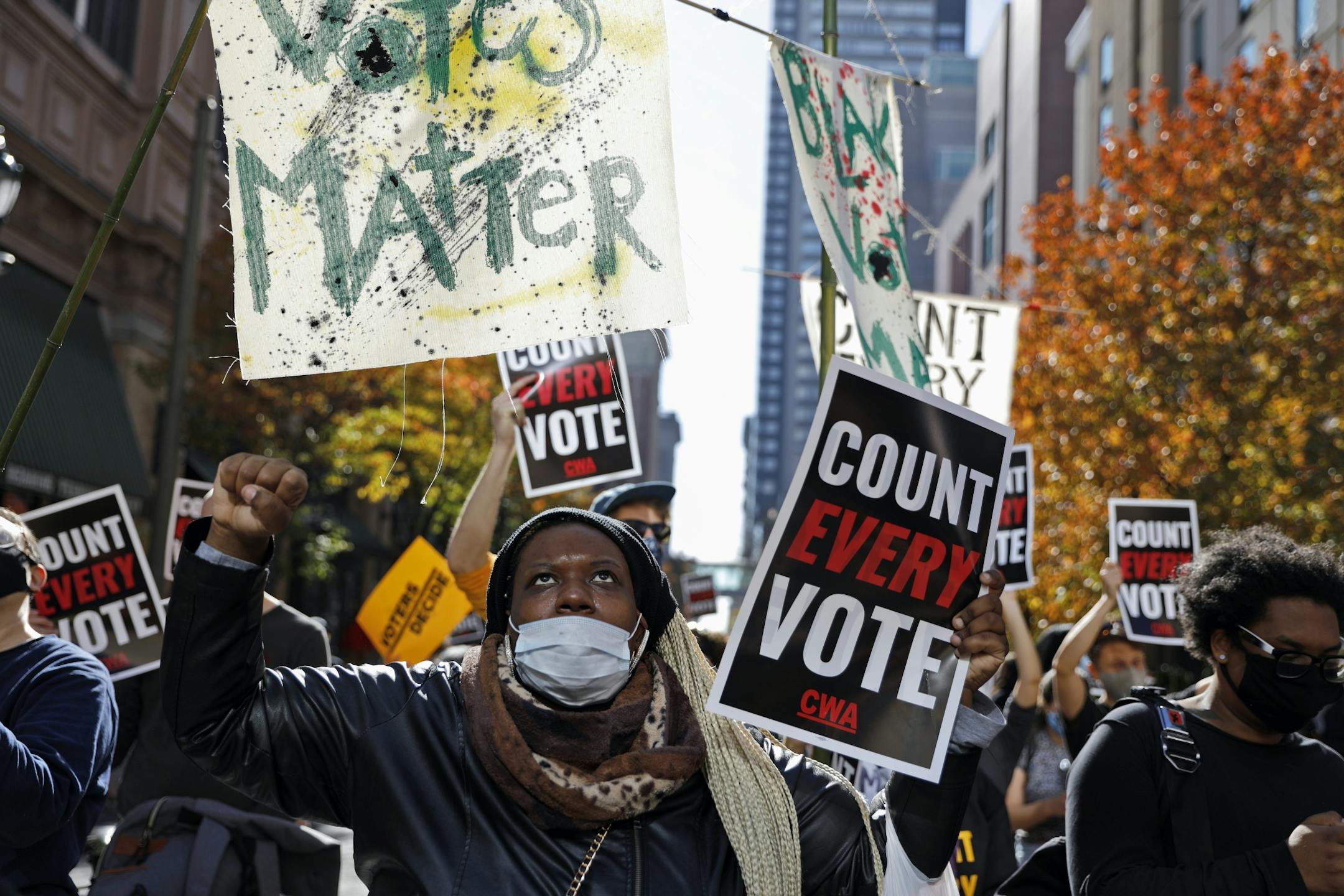 Zhanon Morales, 30, of Philadelphia, raises her fist as demonstrators call for all votes be counted during a rally outside the Pennsylvania Convention Center, Thursday, Nov. 5, 2020, in Philadelphia, as vote counting in the general election continues.